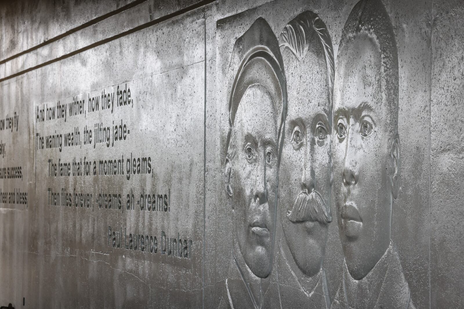 Under the Third Street Bridge is an impression of the two Wright brothers along with Paul Laurence Dunbar. JIM NOELKER/STAFF