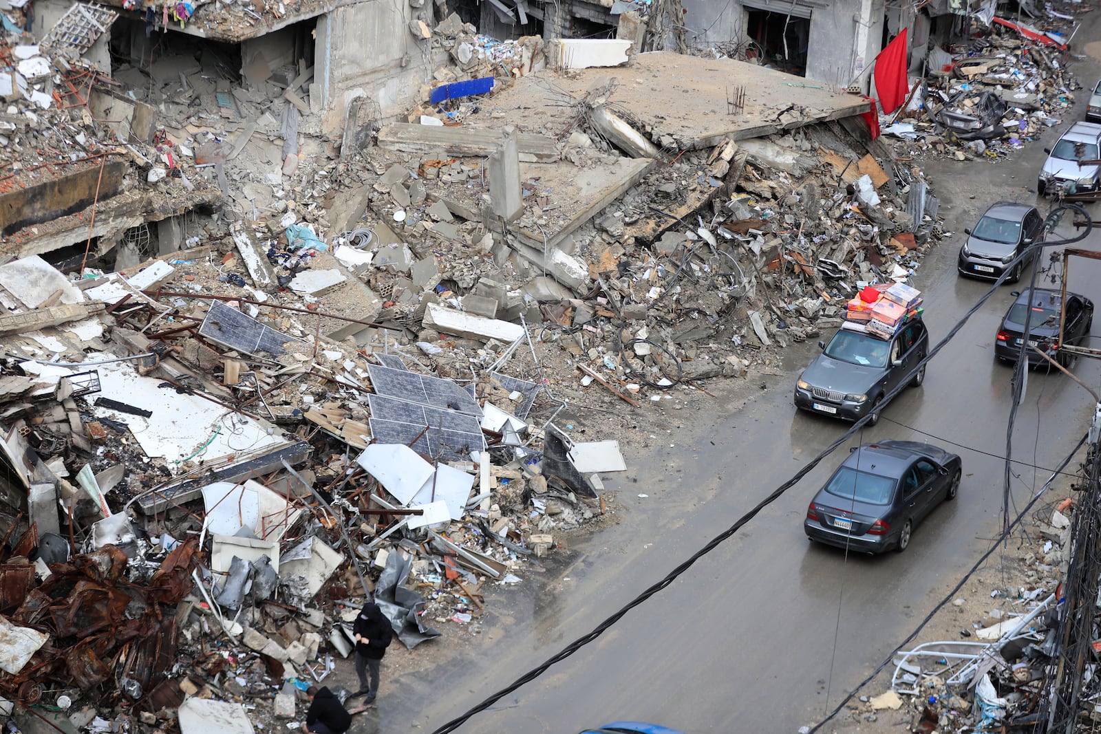 Displaced residents drive past destroyed buildings as they return to Nabatiyeh, Lebanon, after a ceasefire between Israel and Hezbollah went into effect on Wednesday, Nov. 27, 2024. (AP Photo/Mohammed Zaatari)