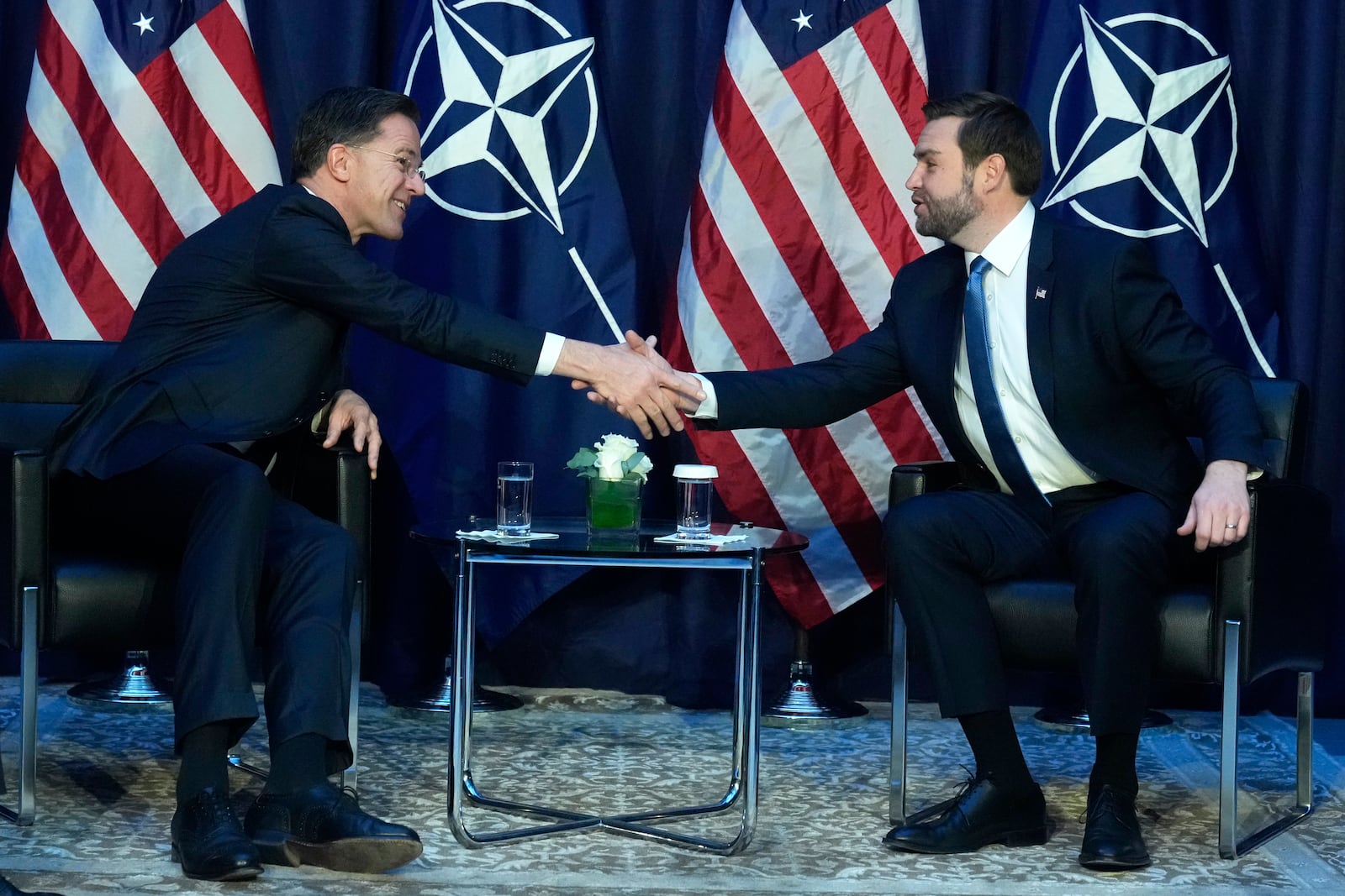 United States Vice-President JD Vance, right, shakes hands with NATO Secretary General Mark Rutte during a bilateral meeting on the sidelines of the Munich Security Conference in Munich, Germany, Friday, Feb. 14, 2025. (AP Photo/Matthias Schrader)