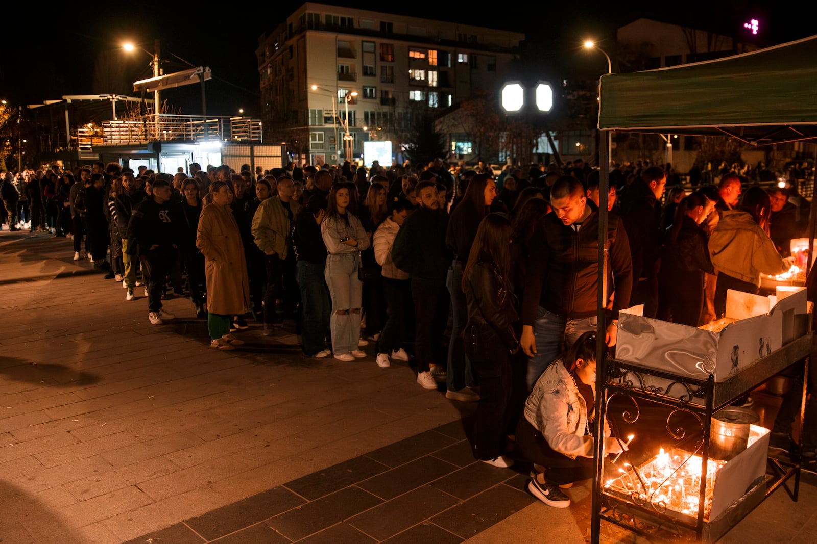 People wait in lines to light candles in the town of Kocani, North Macedonia, Sunday, March 16, 2025, following a massive fire in a nightclub early Sunday. (AP Photo/Visar Kryeziu)