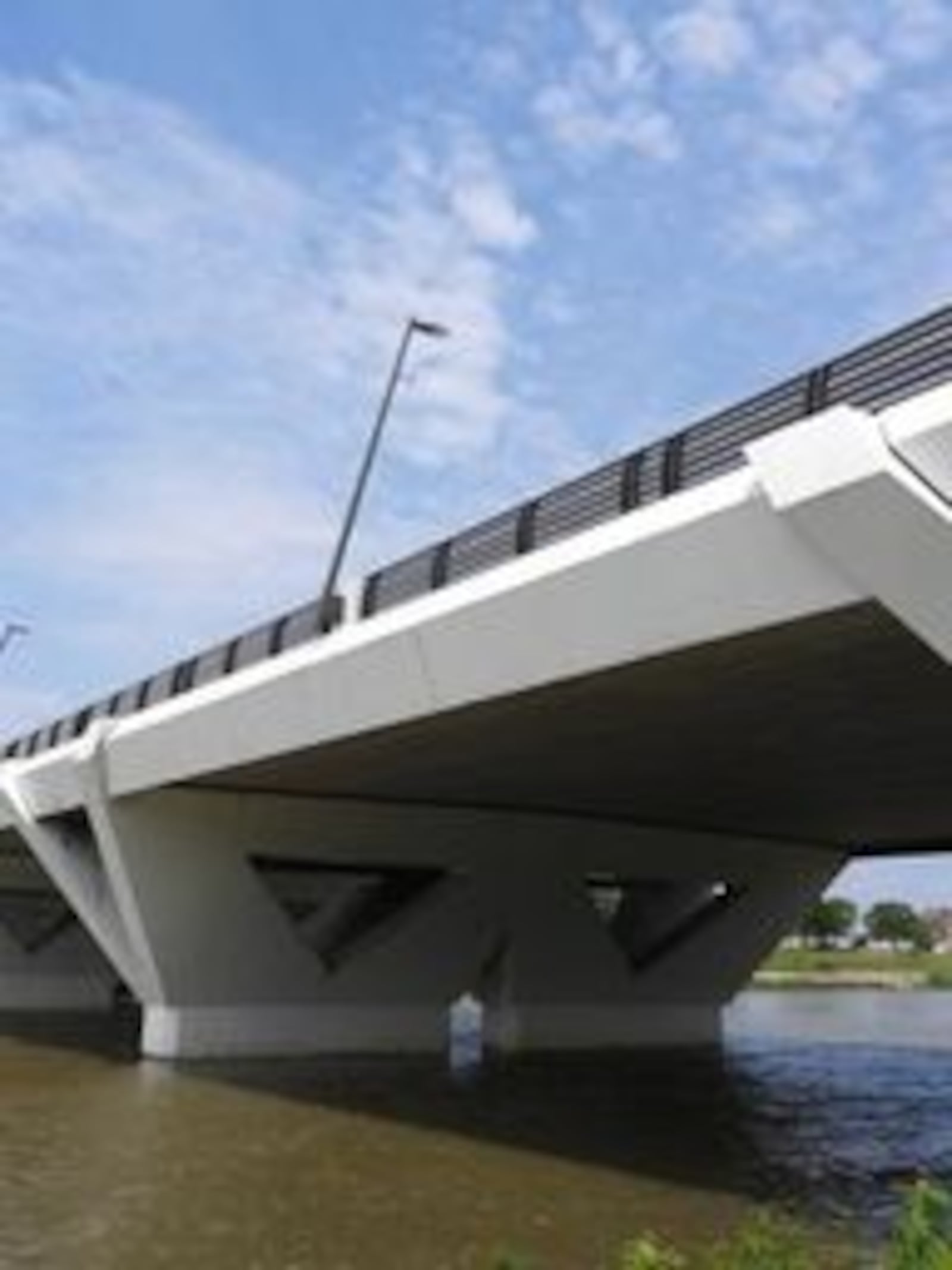 The Stewart Street Bridge's inverted triangular supports are illuminated by color-changing LED lights, which can dance like fireworks or provide a serene landscape. Contributed