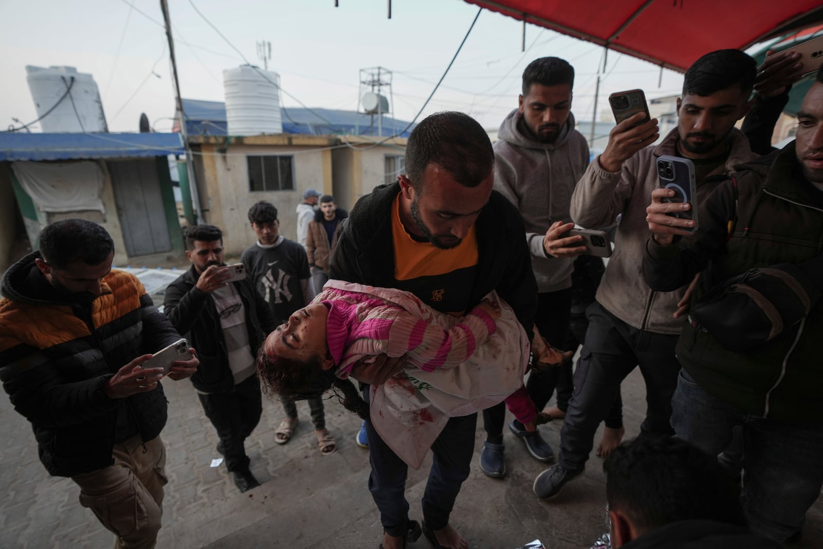 The body of Dima Eid, 5, who was killed in an Israeli airstrike, is brought to Al-Aqsa Hospital in Deir Al-Balah, Gaza, Saturday, Jan. 11, 2025. (AP Photo/Abdel Kareem Hana)