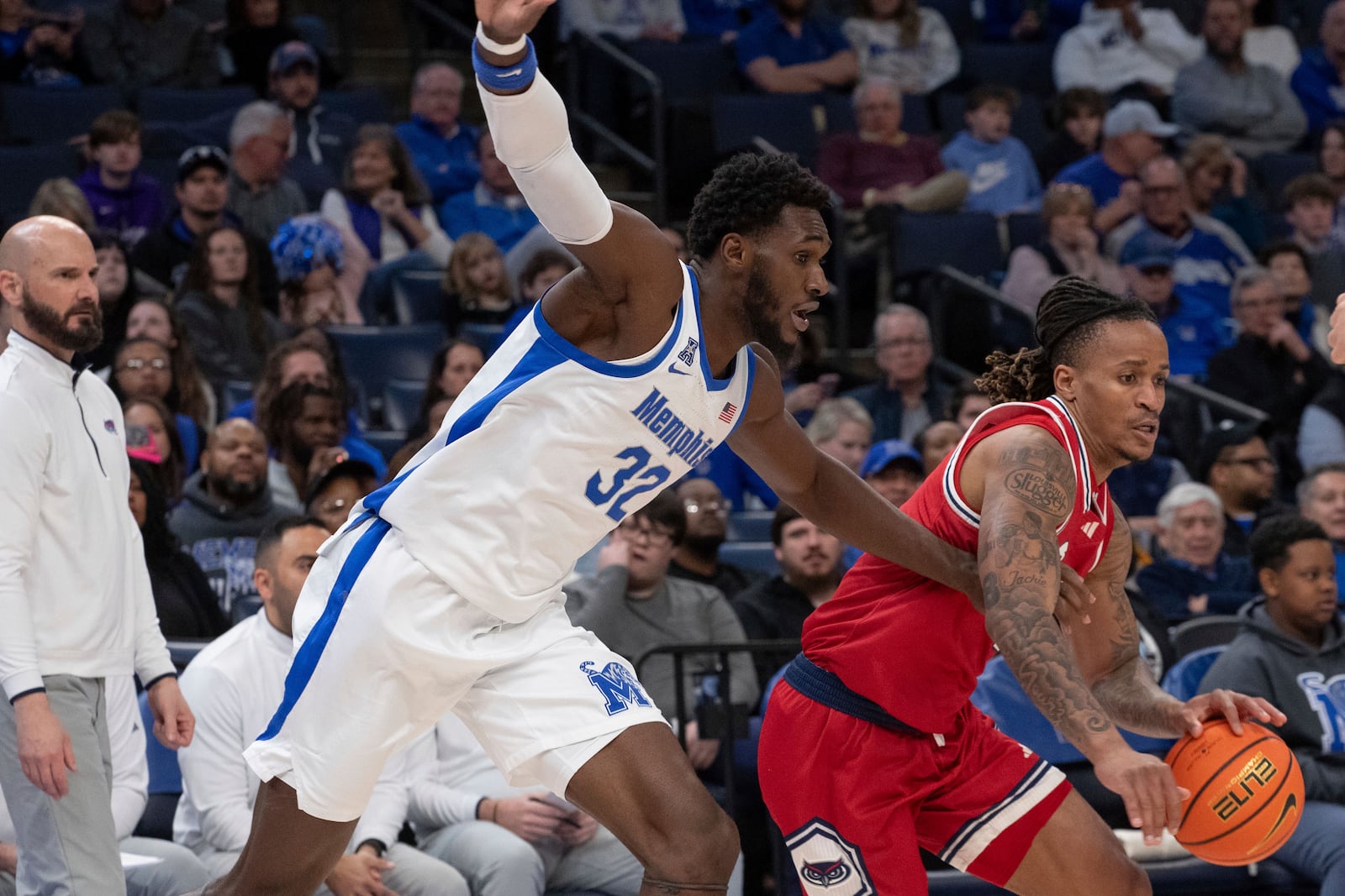 Memphis center Moussa Cisse (32) defends against Florida Atlantic forward Kaleb Glenn, right, during the second half of an NCAA college basketball game Sunday, Feb. 23, 2025, in Memphis, Tenn. (AP Photo/Nikki Boertman)