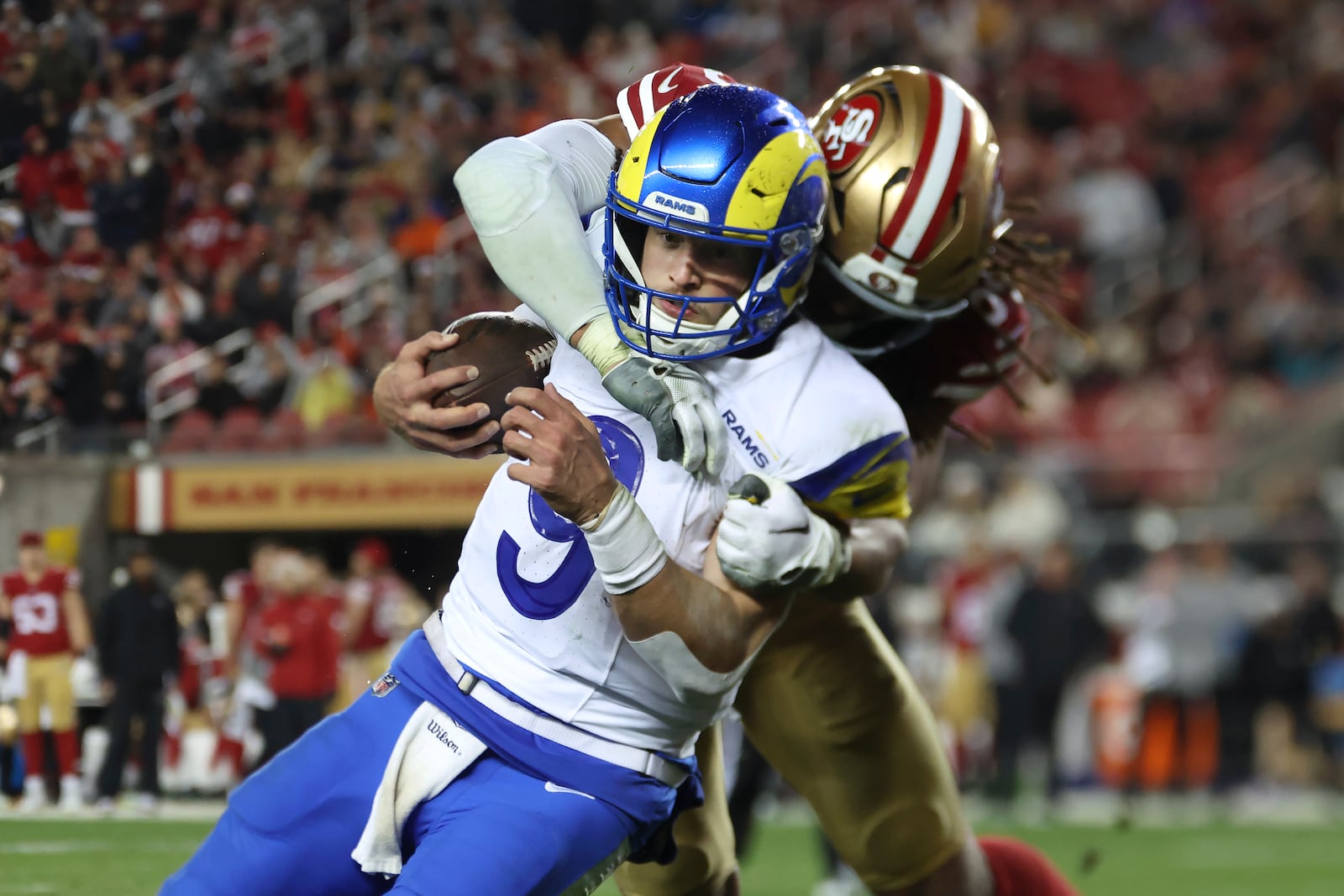 Los Angeles Rams quarterback Matthew Stafford, left, runs against San Francisco 49ers linebacker Fred Warner during the second half of an NFL football game in Santa Clara, Calif., Thursday, Dec. 12, 2024. (AP Photo/Jed Jacobsohn)