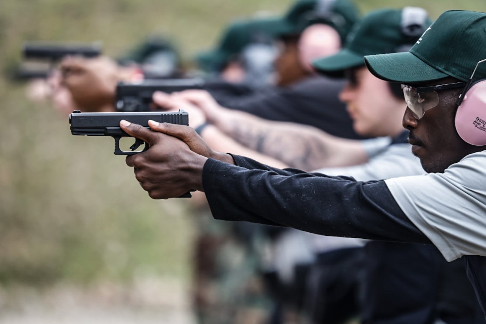 Police cadet Fidele Ngabo trains his handgun aim at the Montgomery County Sheriff's Office shooting range. JIM NOELKER/STAFF