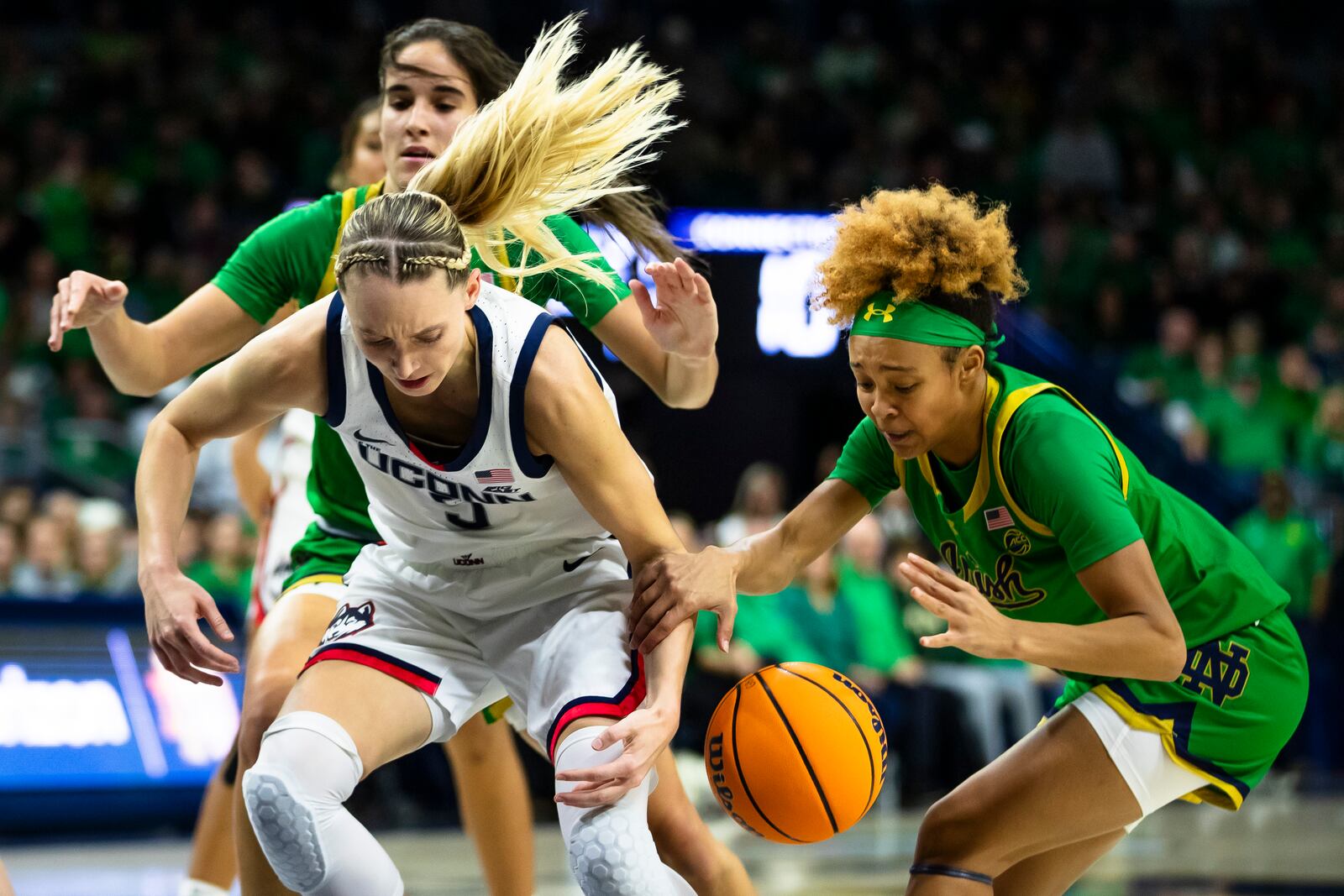 Notre Dame guard Hannah Hidalgo (3) steals the ball from UConn guard Paige Bueckers (5) during the first half of an NCAA college basketball game Thursday, Dec. 12, 2024, in South Bend, Ind. (AP Photo/Michael Caterina)