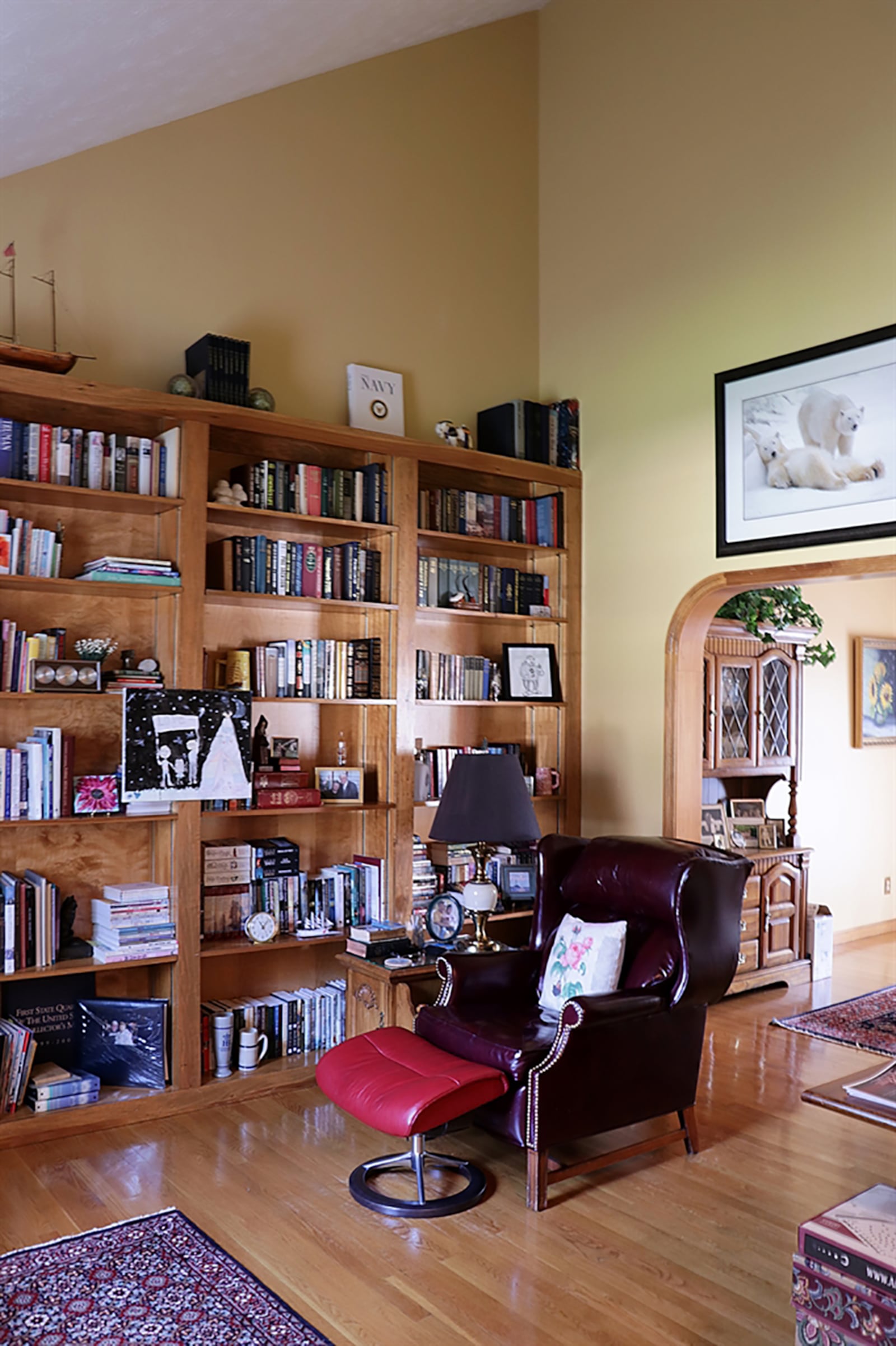 A vaulted ceiling allows for a grand wall of built-in bookcases in the living room, which has been converted to a library sitting room. CONTRIBUTED PHOTO BY KATHY TYLER