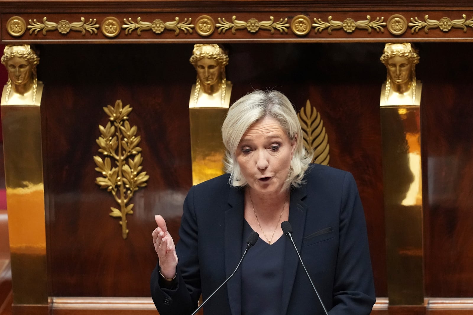 French far-right leader Marine Le Pen delivers her speech at the National Assembly prior to a no-confidence vote that could bring down the Prime Minister and the government for the first time since 1962, Wednesday, Dec. 4, 2024 in Paris. (AP Photo/Michel Euler)