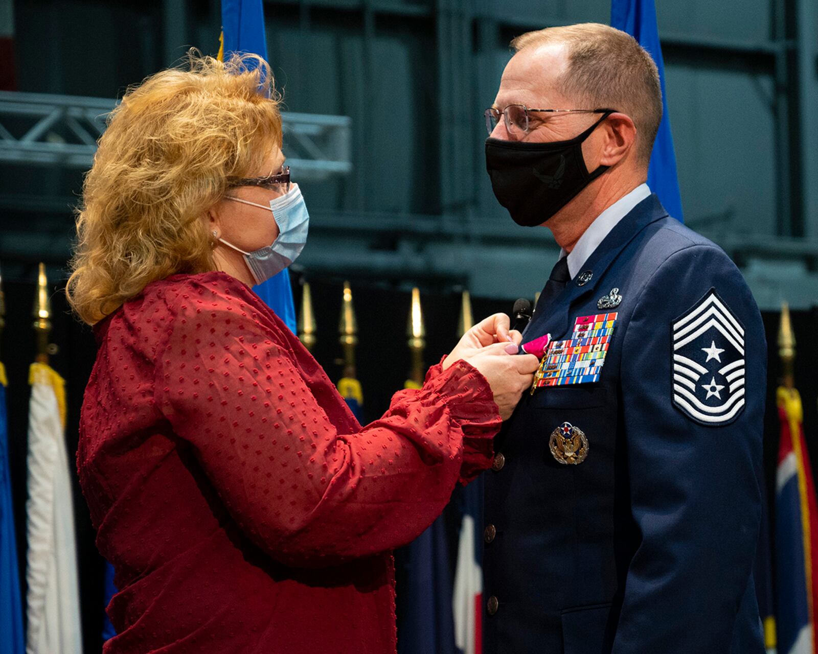 Chief Master Sgt. Stanley Cadell, Air Force Materiel Command command chief, receives his retirement pin from wife, Rhonda, during a farewell ceremony Oct. 1 at Wright-Patterson Air Force Base. Cadell retires after 30 years of service. U.S. AIR FORCE PHOTO/R.J. ORIEZ