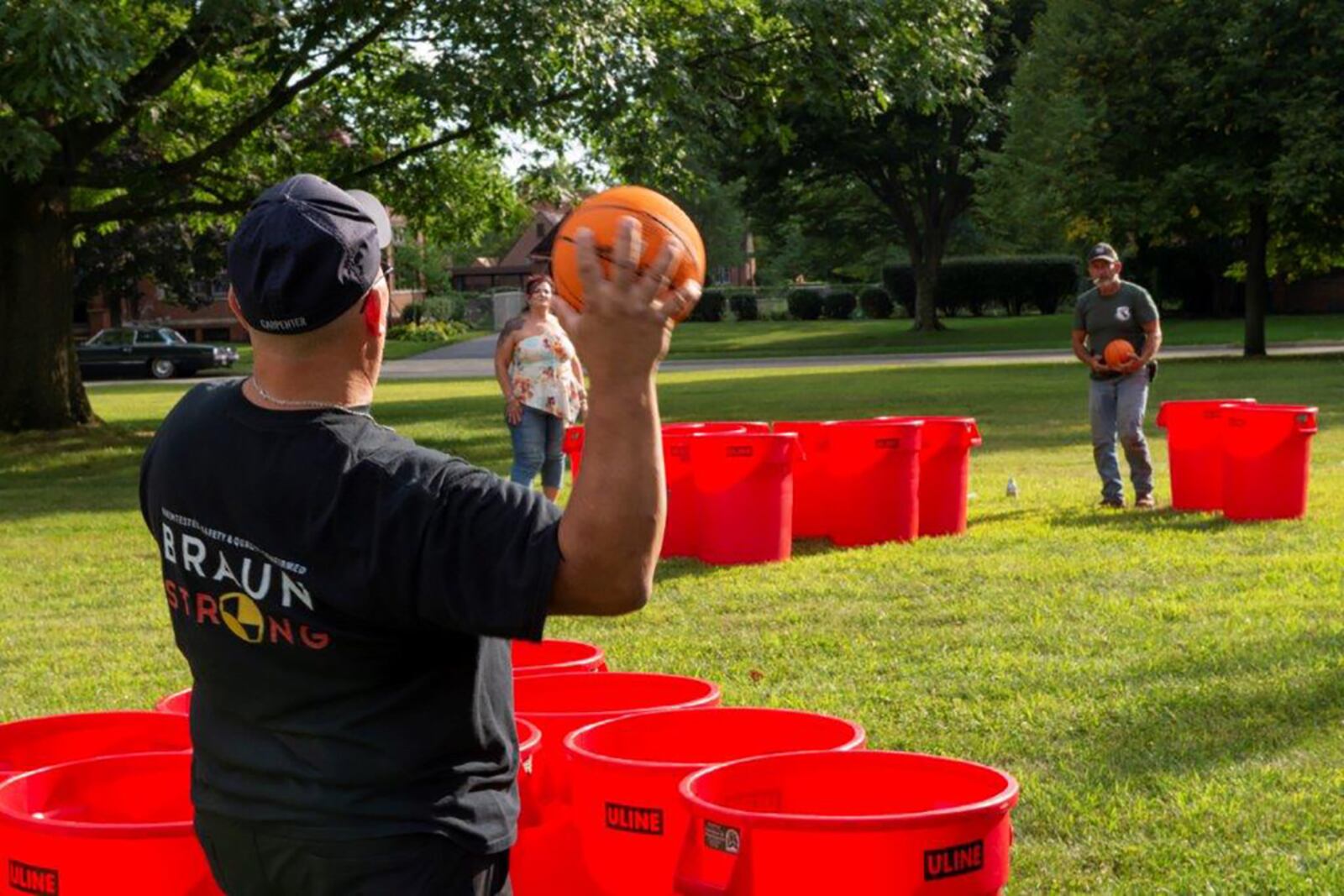 A man takes part in “trash can” basketball Aug. 25 during the Block Party at Turtle Pond. U.S. AIR FORCE PHOTO/AIRMAN 1ST CLASS JAMES JOHNSON