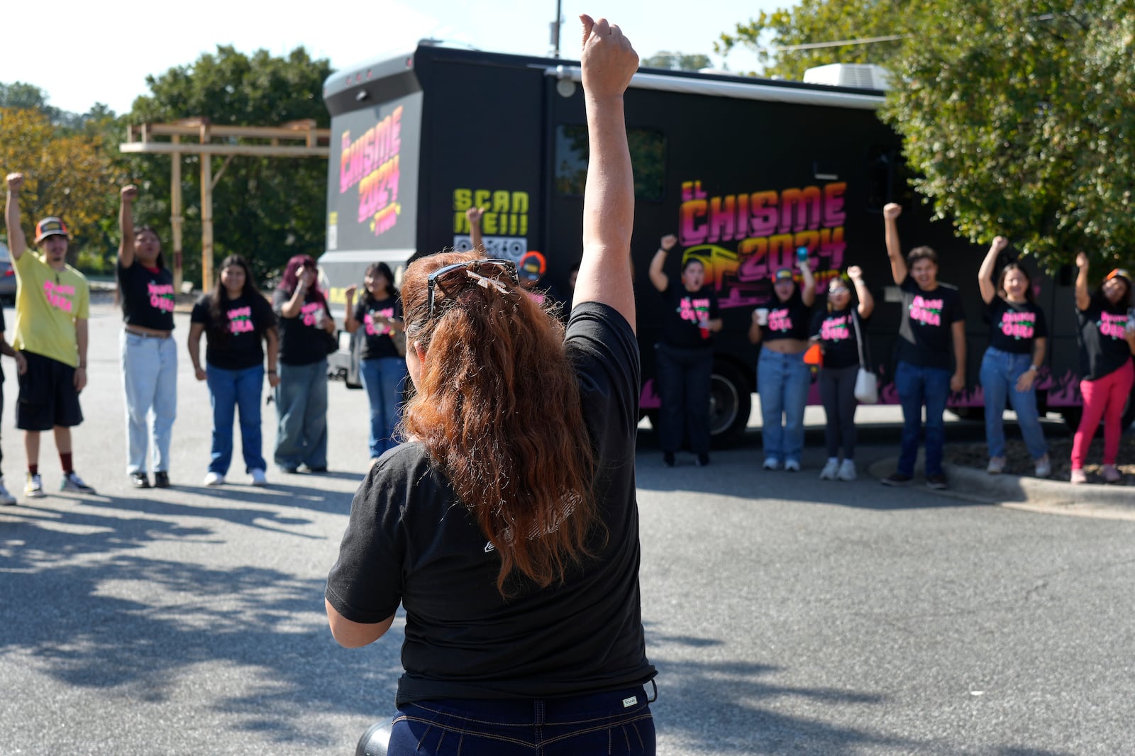 A group leader leads the team in a cheer during a voter engagement event for the Latino community in Greensboro, N.C., Saturday, Sept. 21, 2024. (AP Photo/Chuck Burton)