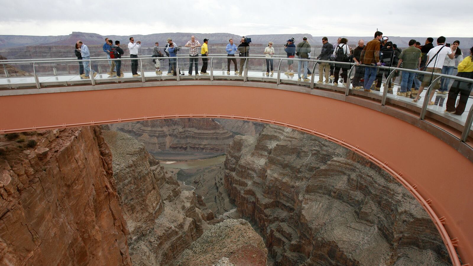 People walk on the Skywalk on the Hualapai Indian Reservation at Grand Canyon West, Arizona, in this March 20, 2007, file photo. The Grand Canyon, which is among the state's biggest tourist destinations, has had three deaths in the span of about two weeks, including a Hong Kong man who fell to his death about 100 yards from the Skywalk on March 28, 2019.