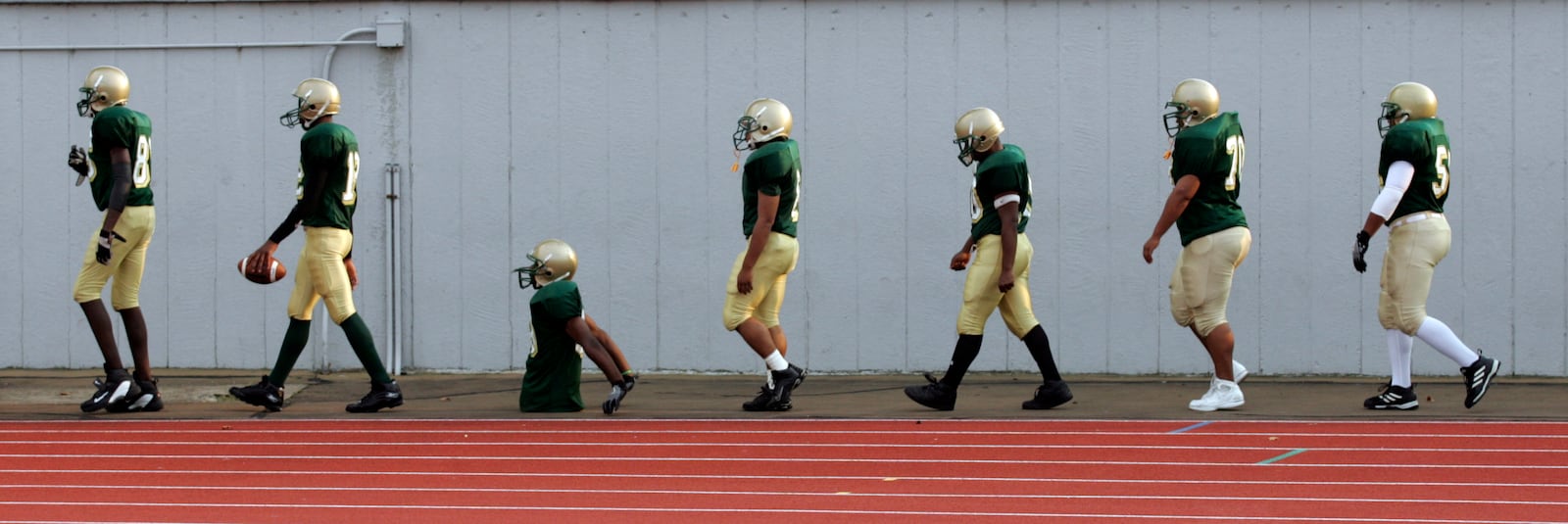 Colonel White's Bobby Martin keeps in perfect step with his teammates as they arrive at Welcome Stadium before a game with Dunbar. Photo by Jim Witmer