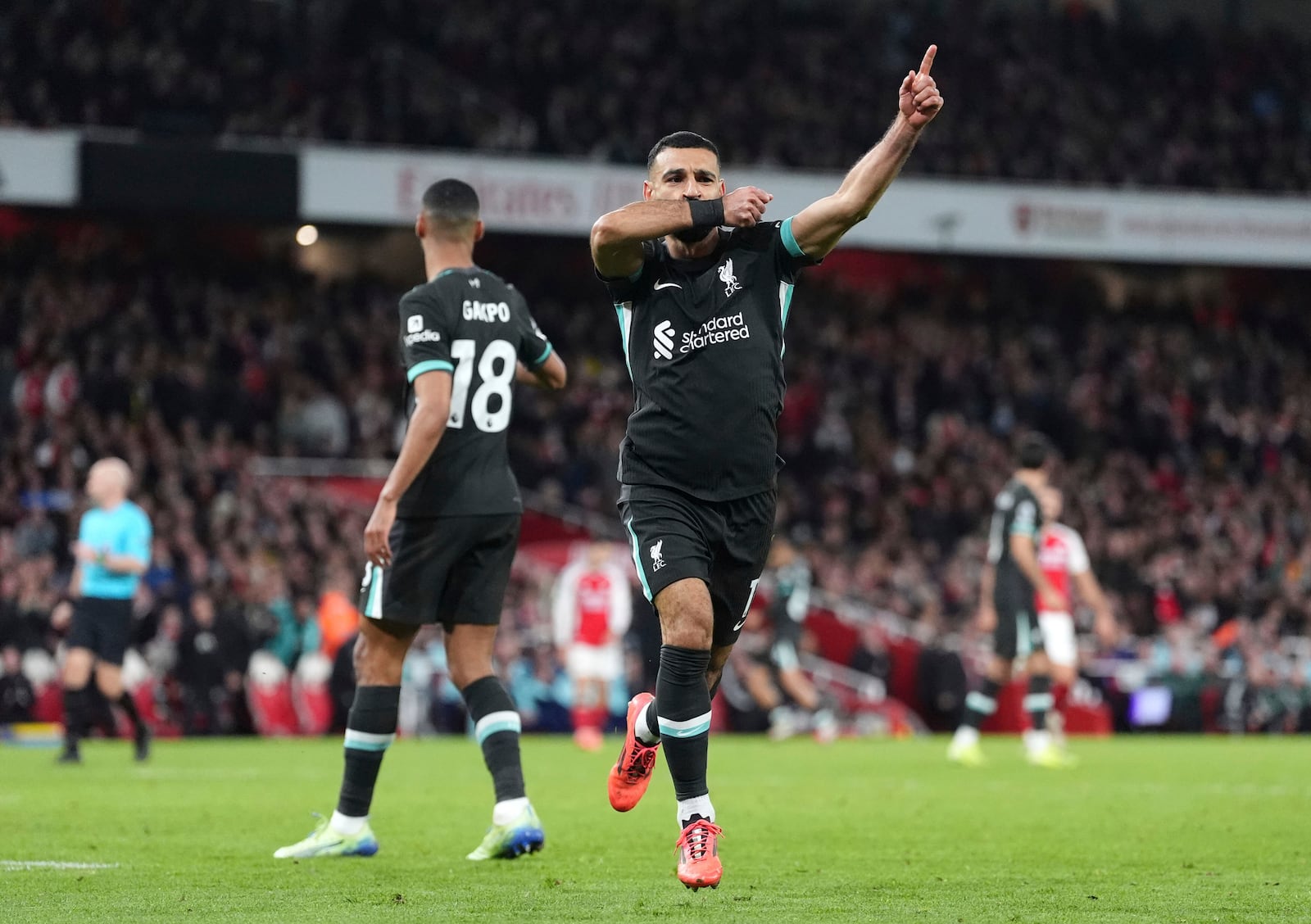 Liverpool's Mohamed Salah celebrates scoring his side's second goal during the English Premier League soccer match between Arsenal and Liverpool, at Emirates Stadium in London, England, Sunday, Oct. 27, 2024. (Adam Davy/PA via AP)