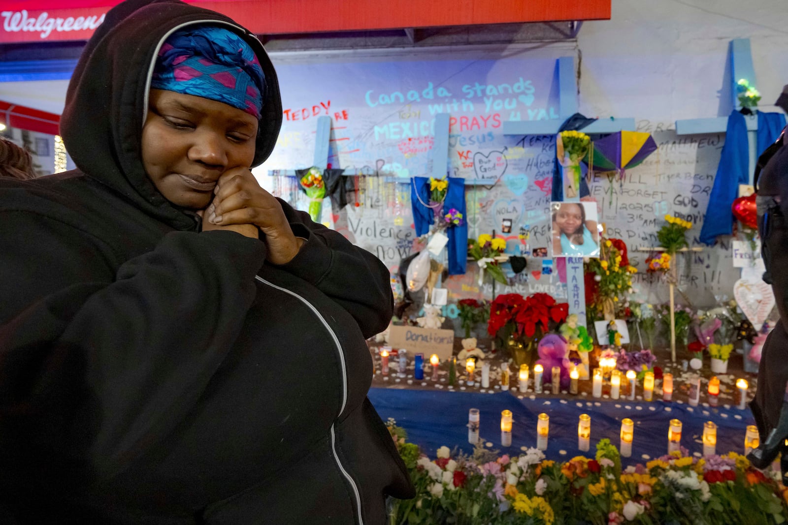 Courtney Polk, cousin of Tasha Polk, who was killed in the New Year's Day attack, reacts at a memorial on Bourbon Street and Canal Street in New Orleans, Saturday, Jan. 4, 2025, (AP Photo/Matthew Hinton)