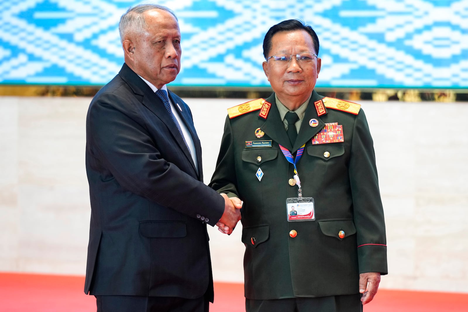 Laos' Defense Minister Chansamone Chanyalath, right, greets Brunei's Defense Minister II Halbi bin Haji Mohd Yussof during the Association of Southeast Asian Nations (ASEAN) defense ministers' meeting in Vientiane, Laos, Wednesday, Nov. 20, 2024. (AP Photo/Anupam Nath)