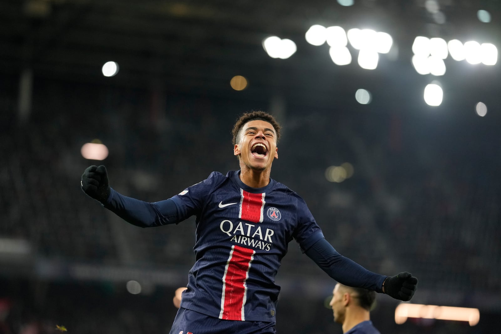 PSG's Desire Doue celebrates after scoring his side's 3rd goal against FC Salzburg during a Champions League opening phase soccer match in Salzburg, Austria, Tuesday, Dec. 10, 2024. (AP Photo/Matthias Schrader)