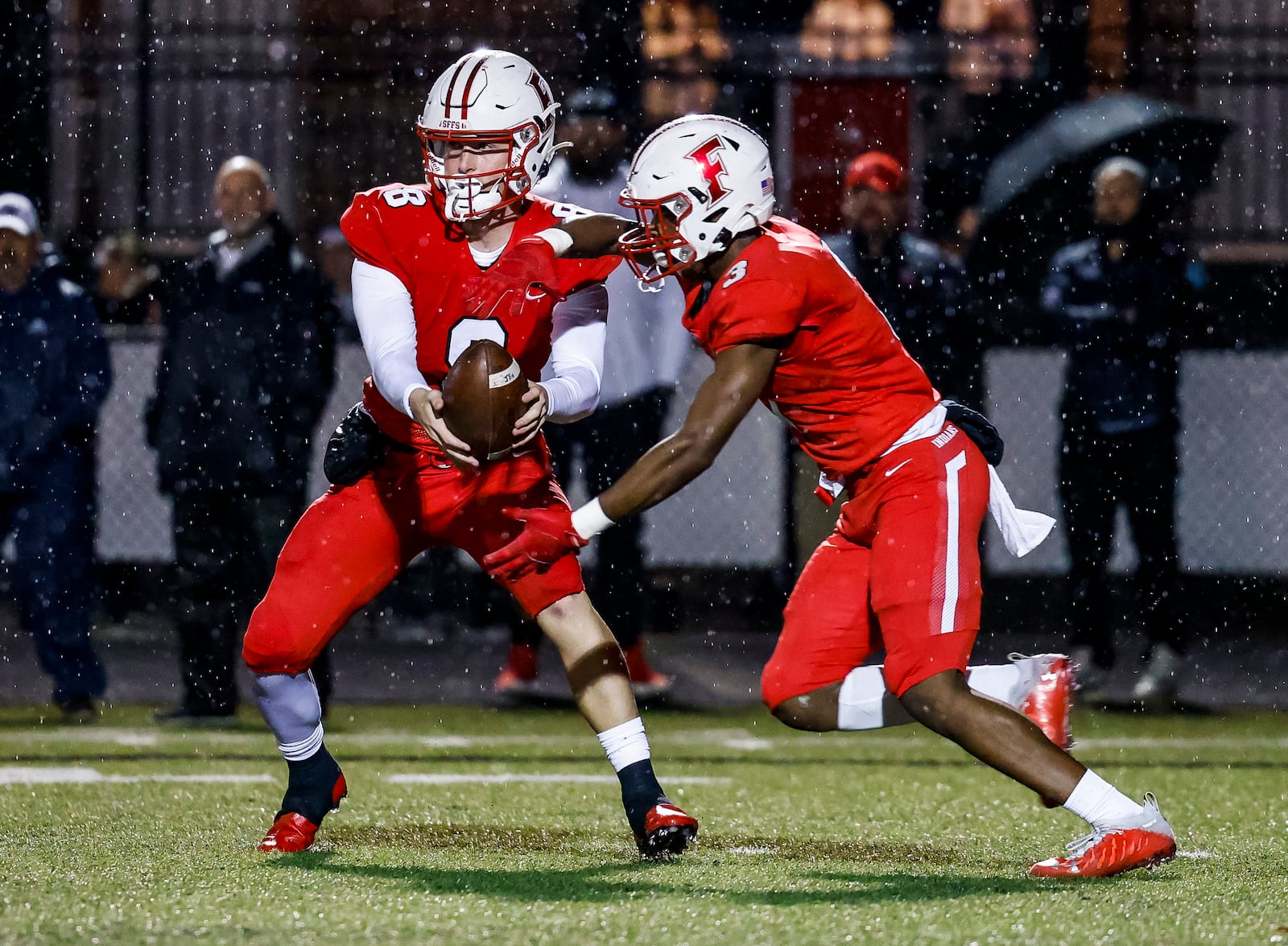 Fairfield quarterback Talon Fisher hands the ball off to running back Jordan Jackson during their Division I playoff game against Mason Friday, Oct. 29, 2021 at Fairfield Stadium. Fairfield won 28-21. NICK GRAHAM/STAFF