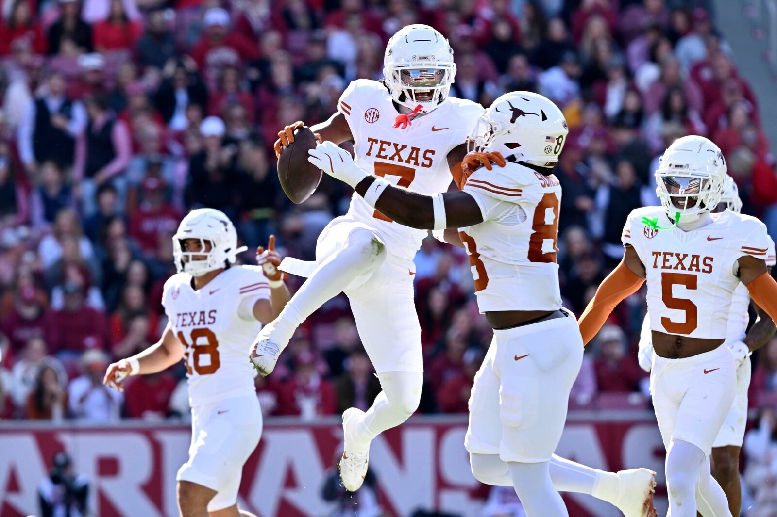 FILE - Texas defensive back Jahdae Barron (7) celebrates with teammate Barryn Sorrell (88) after making in interception against Arkansas during the first half of an NCAA college football game Saturday, Nov. 16, 2024, in Fayetteville, Ark. (AP Photo/Michael Woods, File)