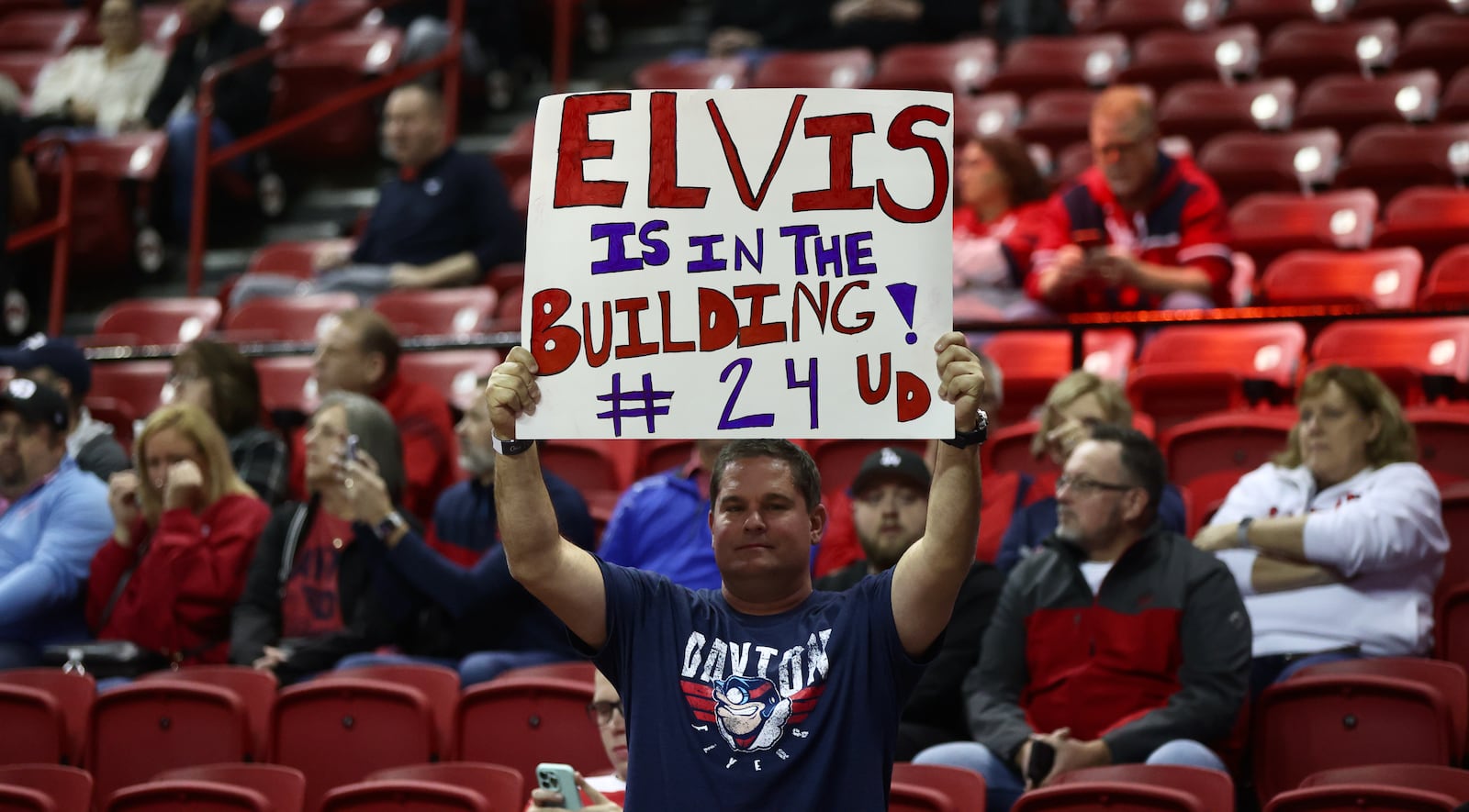 A Dayton fan holds up a sign paying tribute to Kobe Elvis during a game against UNLV on Tuesday, Nov. 15, 2022, at the Thomas & Mack Center in Las Vegas, Nev. David Jablonski/Staff