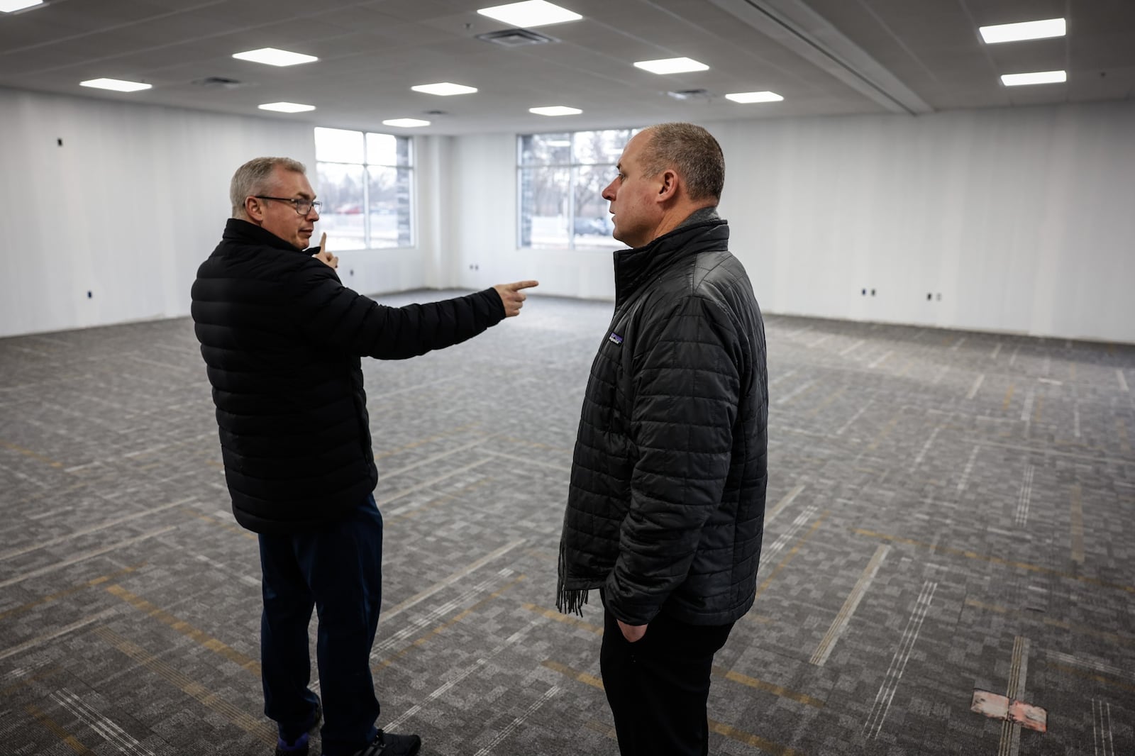 Bill Tolliver, Winsupply vice president for real estate services and in-house counsel, and Rob Ferguson, president of the Winsupply Local Company Group for Winsupply Inc., tour Winsupply's new Richard W. Schwartz Center for Innovation in Moraine. JIM NOELKER/STAFF