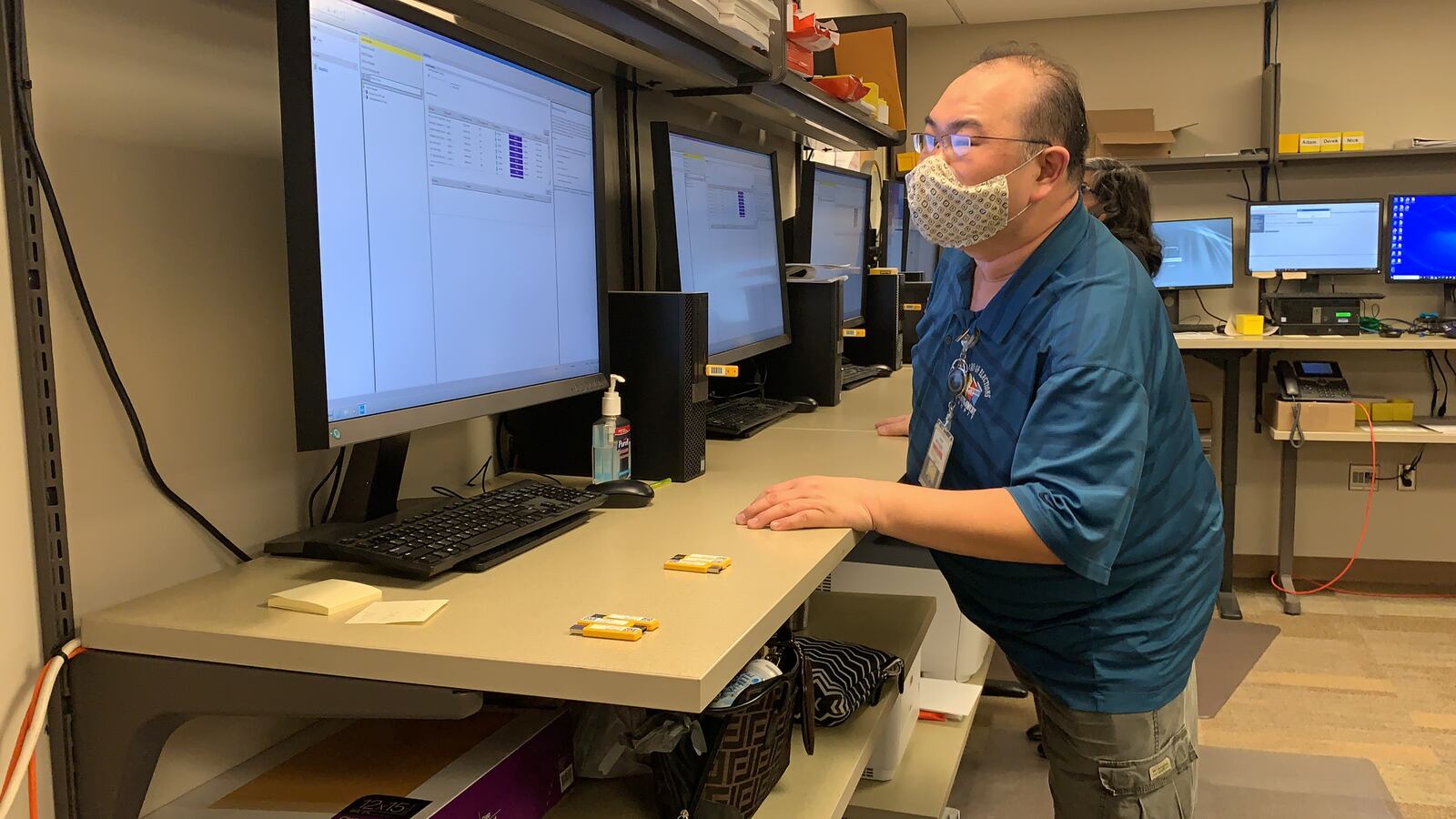 A Montgomery County Board of Elections worker uploads encrypted USB cards containing vote tallies to a computer not connected to the internet that adds it to the total vote.