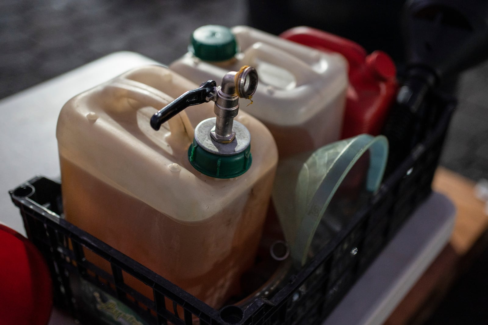 Containers filled with Petgas gasoline, produced from plastic, are seen at the Petgaserita plant in Boca del Rio, Veracruz, Mexico, Jan. 4, 2025. (AP Photo/Felix Marquez)