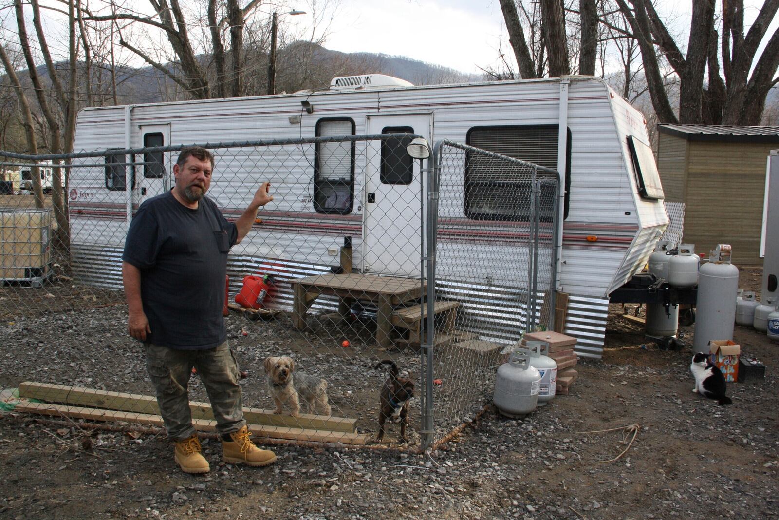 Danny Bailey, 61, stands in front of the trailer he lives in with his pet dogs in Swannanoa, N.C., on Thursday, Feb. 6, 2025. (AP Photo/Makiya Seminera)