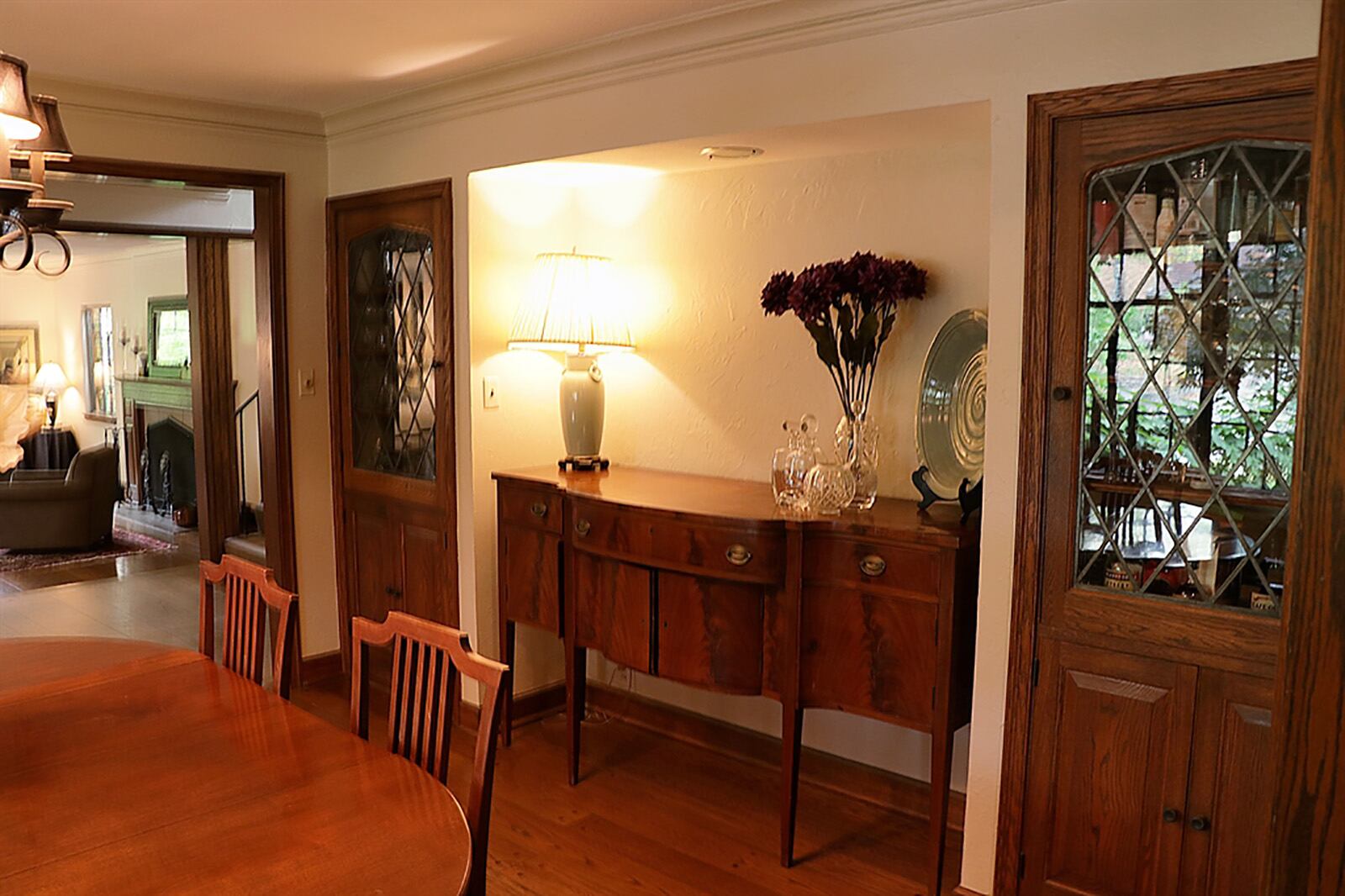 The dining room has a buffet nook flanked by built-in China hutches that have leaded-glass doors. Off the dining room is a serving room with built-in bookcases surrounding a window. CONTRIBUTED PHOTO BY KATHY TYLER