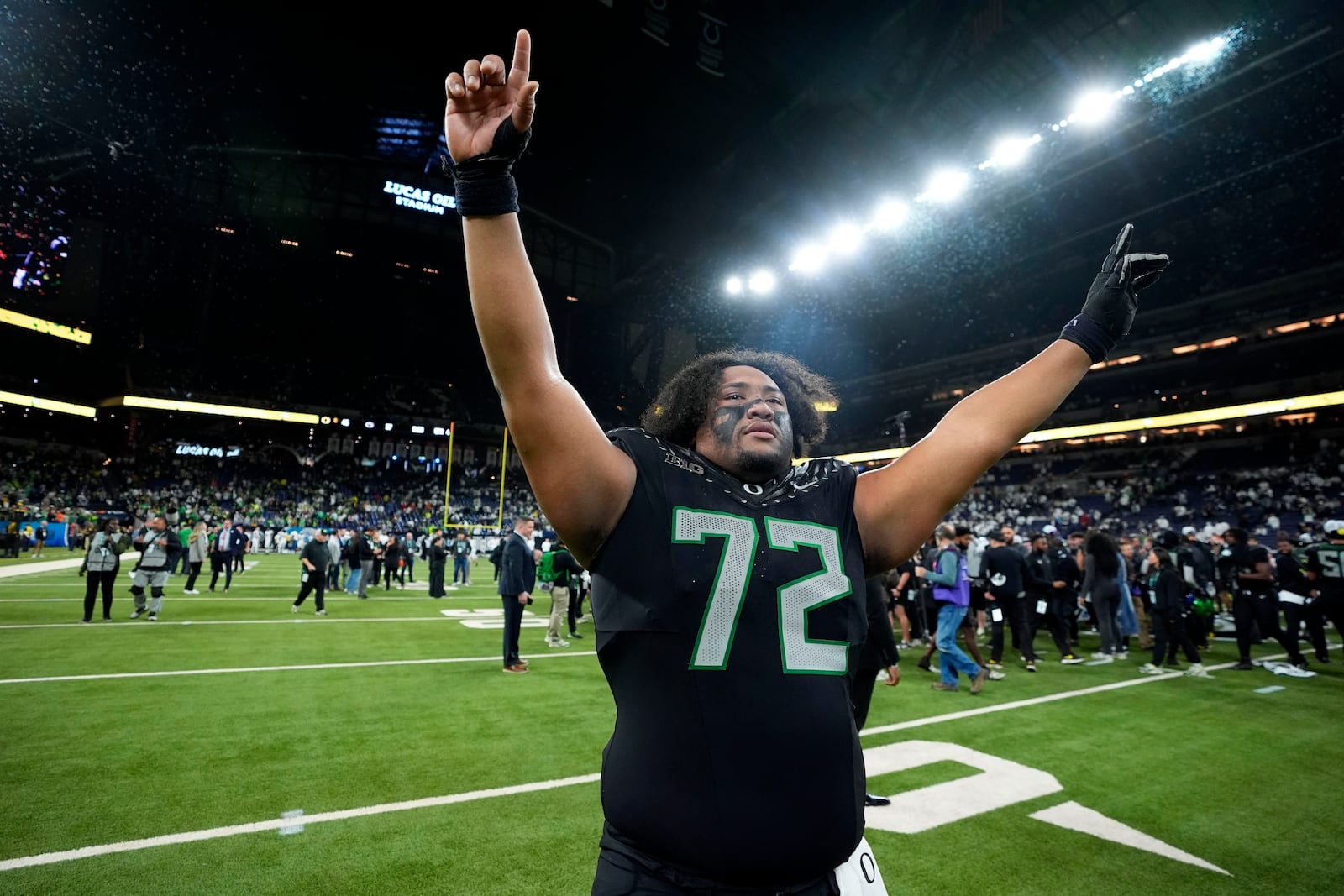 Oregon offensive lineman Iapani Laloulu celebrates after the Big Ten championship NCAA college football game against Penn State, Saturday, Dec. 7, 2024, in Indianapolis. (AP Photo/Darron Cummings)