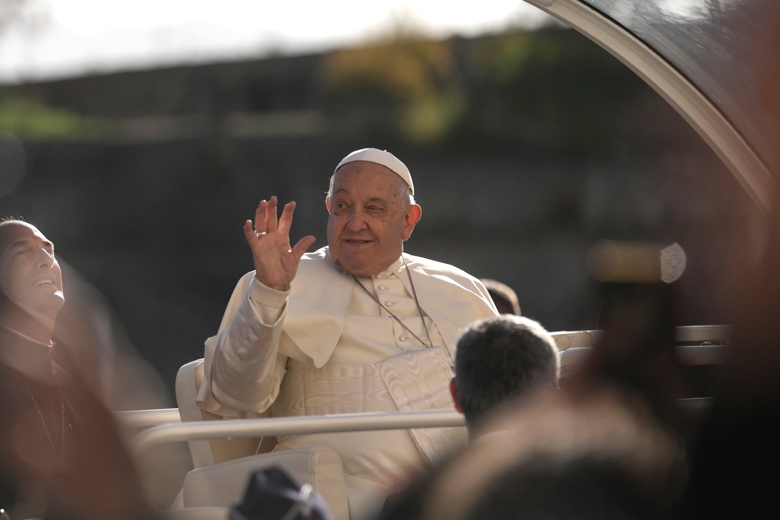 Pope Francis gestures near the Notre Dame of the Assumption cathedral Sunday, Dec. 15, 2024 in Ajaccio, Corsica island. Pope Francis' one-day visit to the French island of Corsica puts a dual focus on the Mediterranean, highlighting local traditions of popular piety on the one hand and migrant deaths and wars on the other. (AP Photo/Thibault Camus)