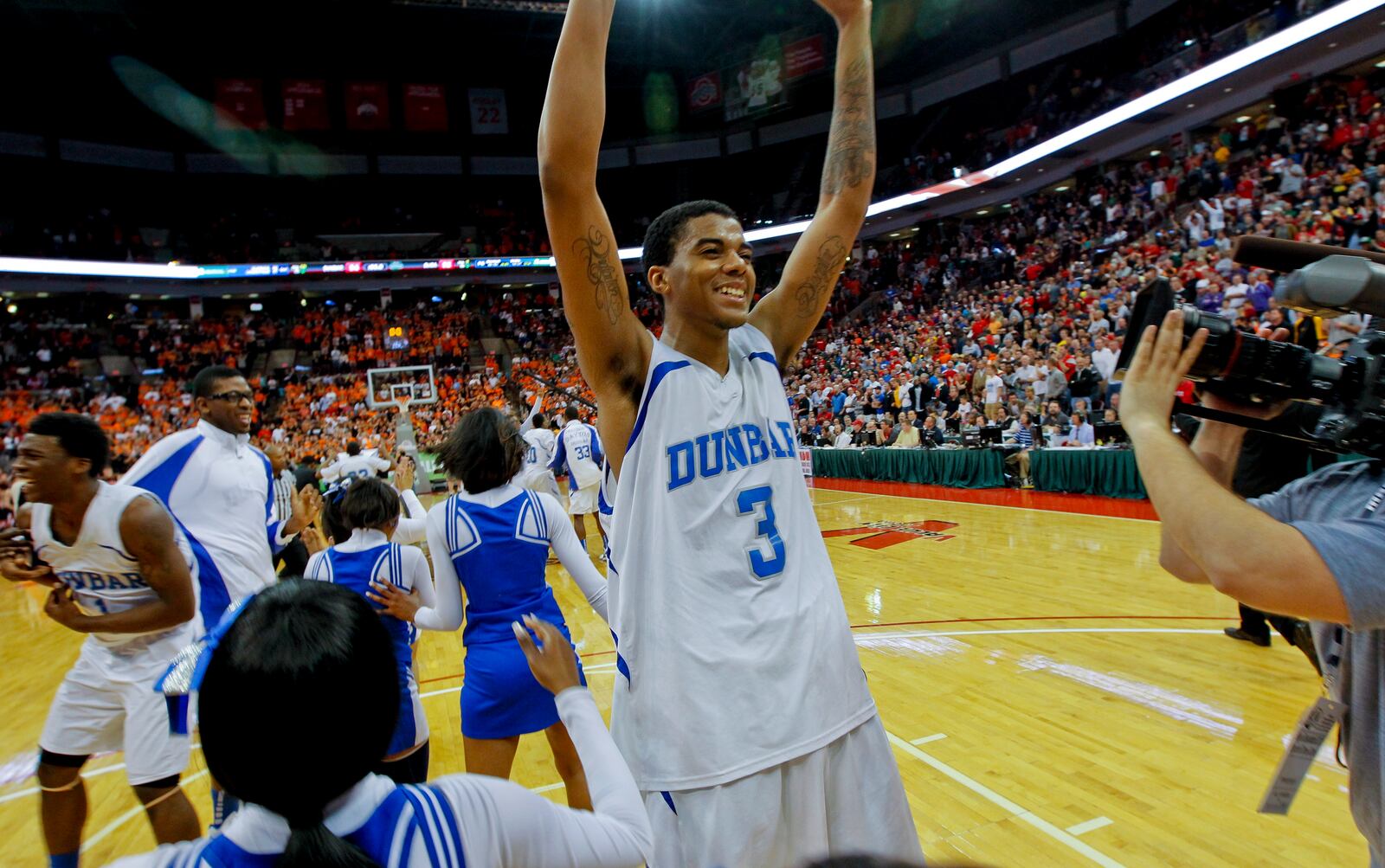 Dunbar's Deontae Hawkins celebrates with the rest of his team after wins the Division II boys high school state championship basketball game against Elida Saturday, March 24, 2012 for the at the OSU Schottenstein Center in Columbus, Ohio. Staff photo by Gary Stelzer