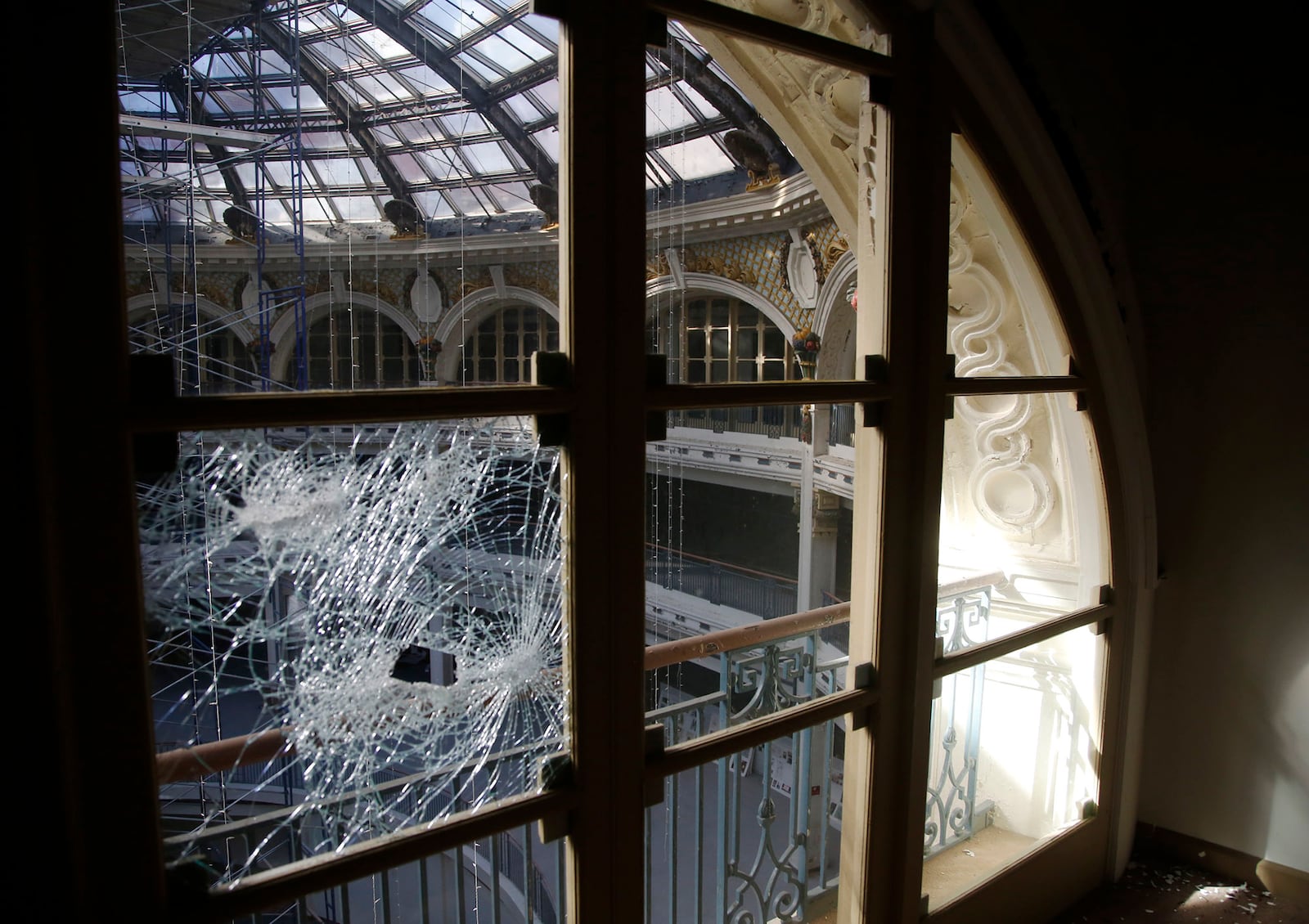 Cracked arched window and French door on the third floor of the Dayton Arcade will be renovated into office co-share space with the Innovation Center in phase one.   TY GREENLEES / STAFF