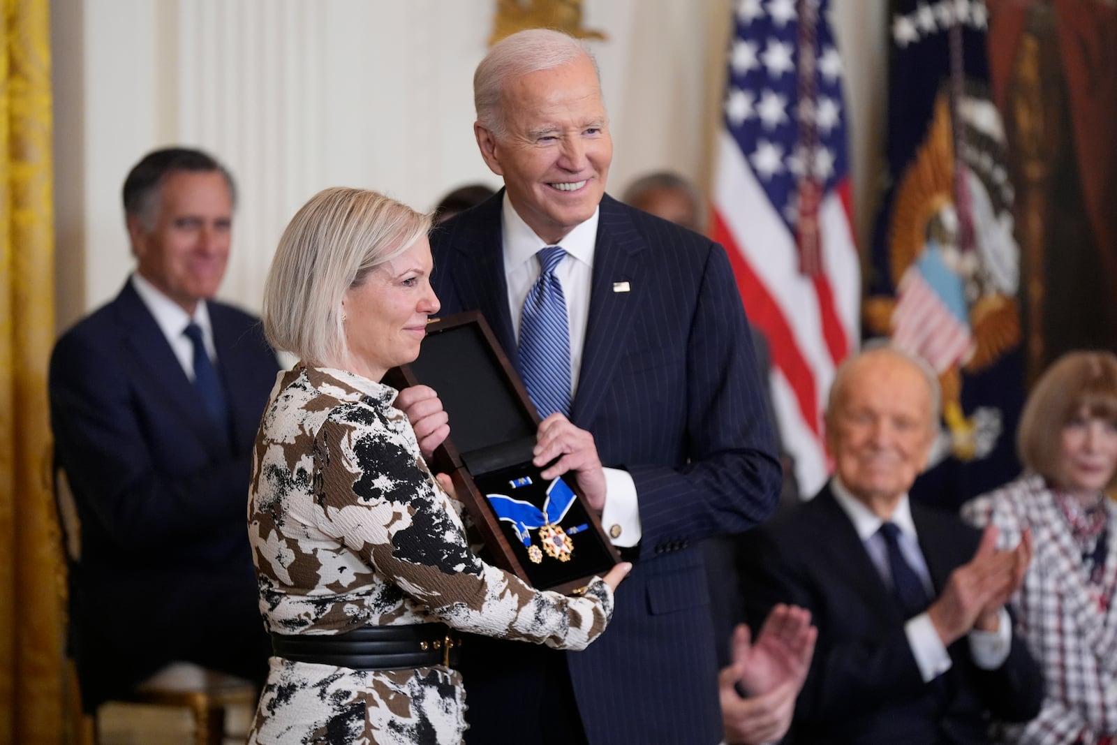 President Joe Biden, right, posthumously presents the Presidential Medal of Freedom, the Nation's highest civilian honor, to Stephanie Carter, left, on behalf of her late husband former Defense Secretary Ash Carter, in the East Room of the White House, Saturday, Jan. 4, 2025, in Washington. (AP Photo/Manuel Balce Ceneta)