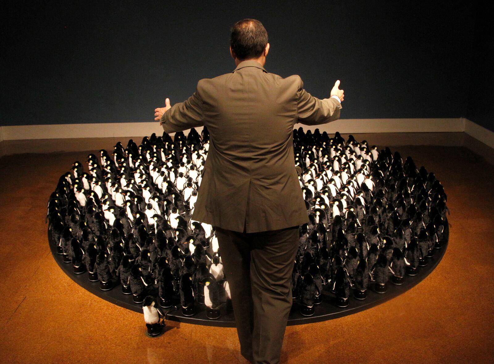 Michael Roediger, director and CEO of the Dayton Art Institute, makes 450 penguins follow his movements. The "Penguins Mirror" by artist Daniel Rozin is one of three installations that is part of the new exhibit, "The Antarctic Sublime & Elements of Nature: Water". The exhibit will run through Oct. 16, 2016. LISA POWELL / STAFF