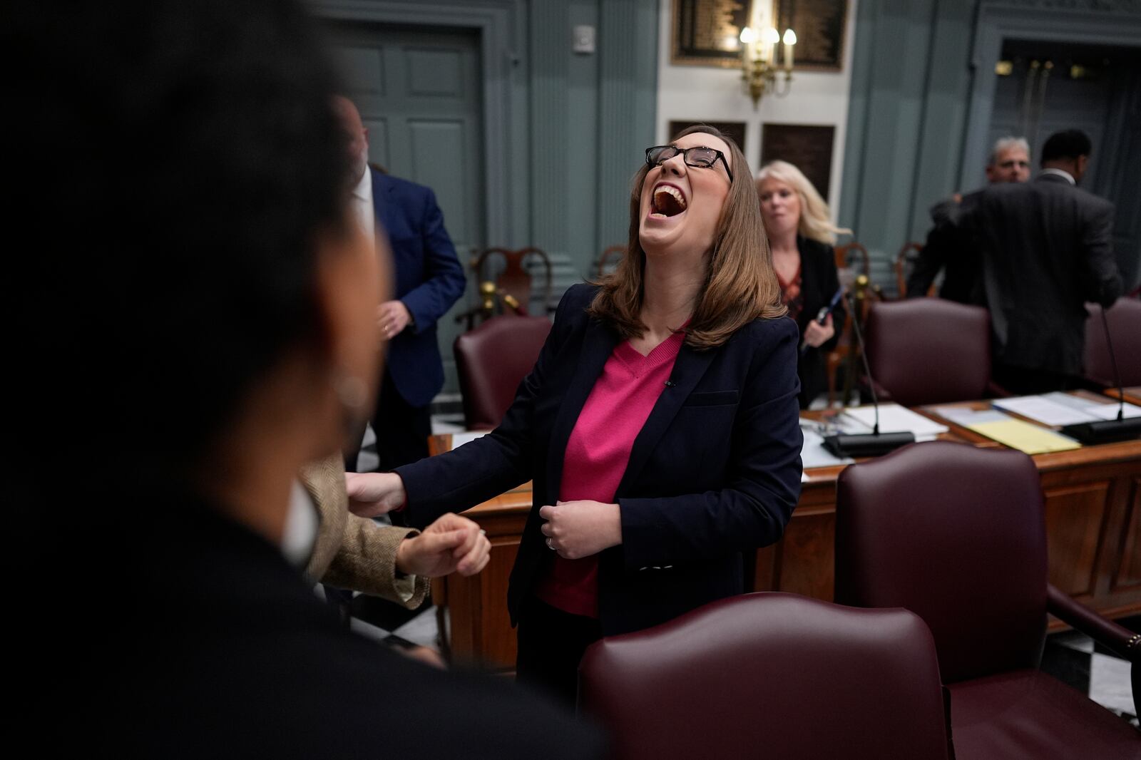 U.S.-Rep.-elect Sarah McBride, D-Del., laughs with fellow lawmakers after her farewell speech on the Senate floor during a special session, her last day as a Delaware state senator, at the Delaware Legislative Hall in Dover, Del., Monday, Dec. 16, 2024. (AP Photo/Carolyn Kaster)