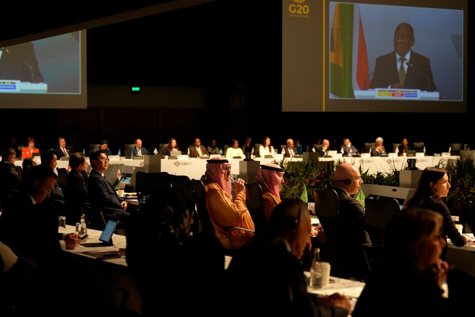 Delegates watch South Africa's President Cyril Ramaphosa addressing them at the G20 Finance Ministers and Central Bank Governors meeting in Cape Town, South Africa, Wednesday, Feb. 26, 2025. (AP Photo/Nardus Engelbrecht)