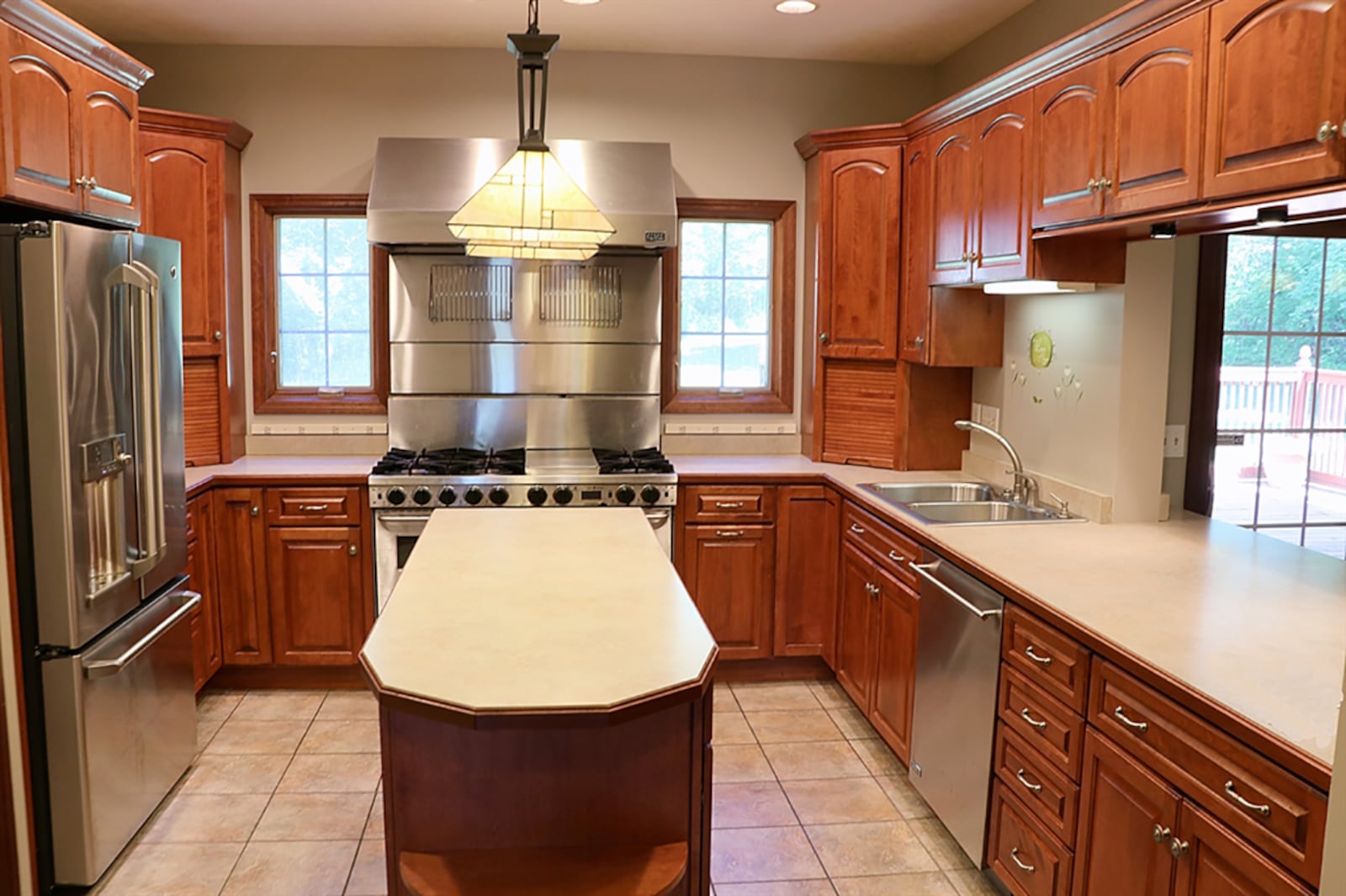 The family room and adjoining breakfast room are divided from the kitchen by a peninsula counter. The kitchen has an abundance of cabinetry and counter space within its U-shaped design. CONTRIBUTED PHOTO BY KATHY TYLER