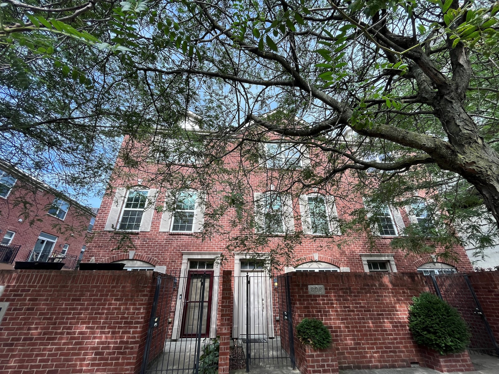 A tree in front of a townhome in the Patterson Square housing development in downtown Dayton. CORNELIUS FROLIK / STAFF