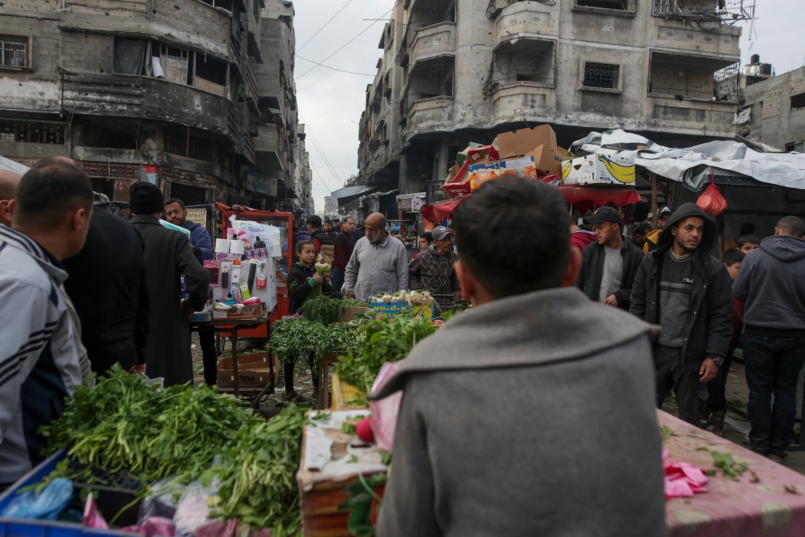 Palestinians shop at Sheikh Radwan Market, west of Gaza City, before the Iftar, the fast-breaking meal, during the holy month of Ramadan on Monday, March 3, 2025. (AP Photo/Jehad Alshrafi)