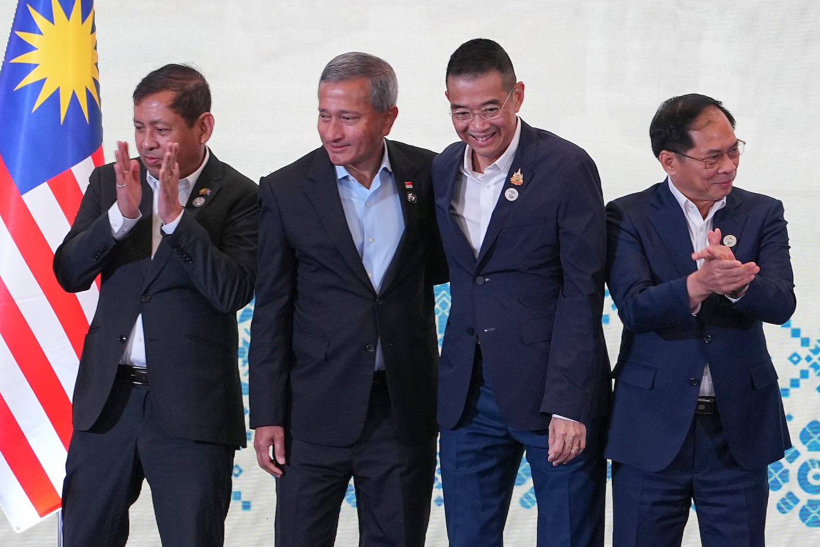 From left to right, Myanmar's Permanent Secretary to ASEAN Aung Kyaw Moe, Singapore's Foreign Minister Vivian Balakrishnan, Thailand's Foreign Minister Maris Sangiampongsa and Vietnam's Foreign Minister Bui Thanh Son react after a group photo session during the Association of Southeast Asian Nations (ASEAN) Foreign Ministers' Retreat in Langkawi Island, Malaysia, Sunday, Jan. 19, 2025. (AP Photo/Azneal Ishak, Pool)