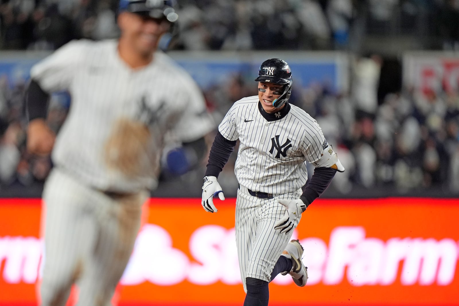 New York Yankees' Aaron Judge, right, runs the bases behind Gleyber Torres after hitting a two-run home run against the Cleveland Guardians during the seventh inning in Game 2 of the baseball AL Championship Series Tuesday, Oct. 15, 2024, in New York. (AP Photo/Frank Franklin II)