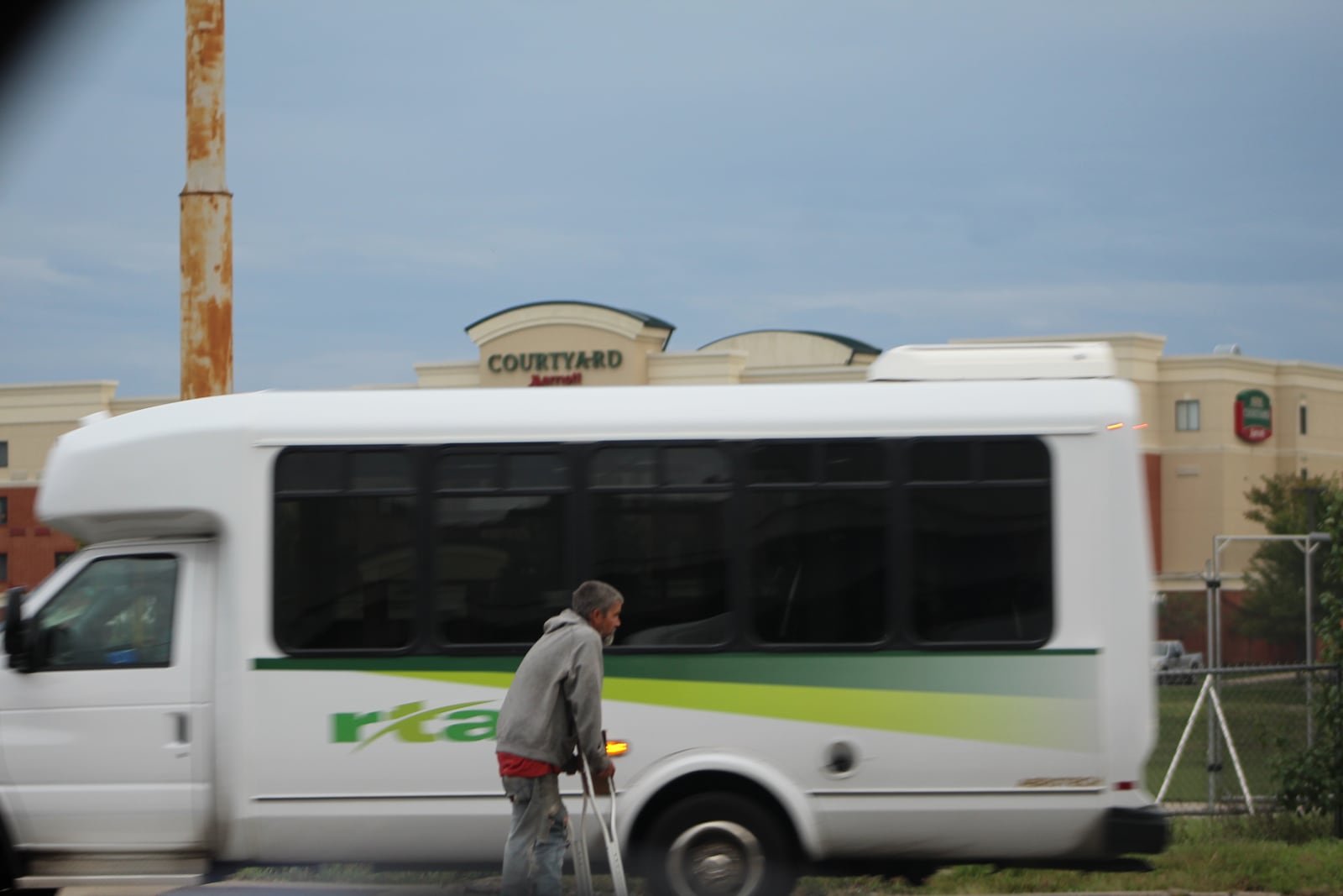 A man on crutches asks for money on the side of the road in southwest Dayton. CORNELIUS FROLIK / STAFF