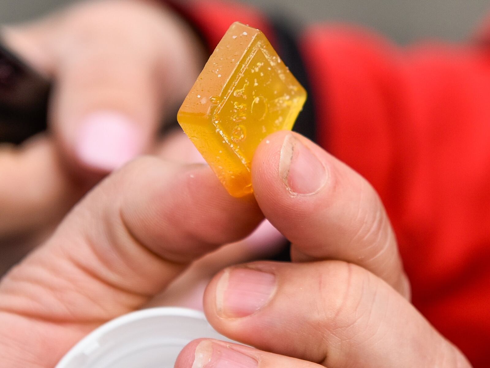 Melissa West, from West Chester Township, was among those lined up outside the doors on the first day of operations for About Wellness Ohio, the region’s first medical marijuana dispensary, Tuesday, May 21, 2019 on Genntown Drive in Lebanon. She shows the edible product she obtained during her visit. NICK GRAHAM/STAFF