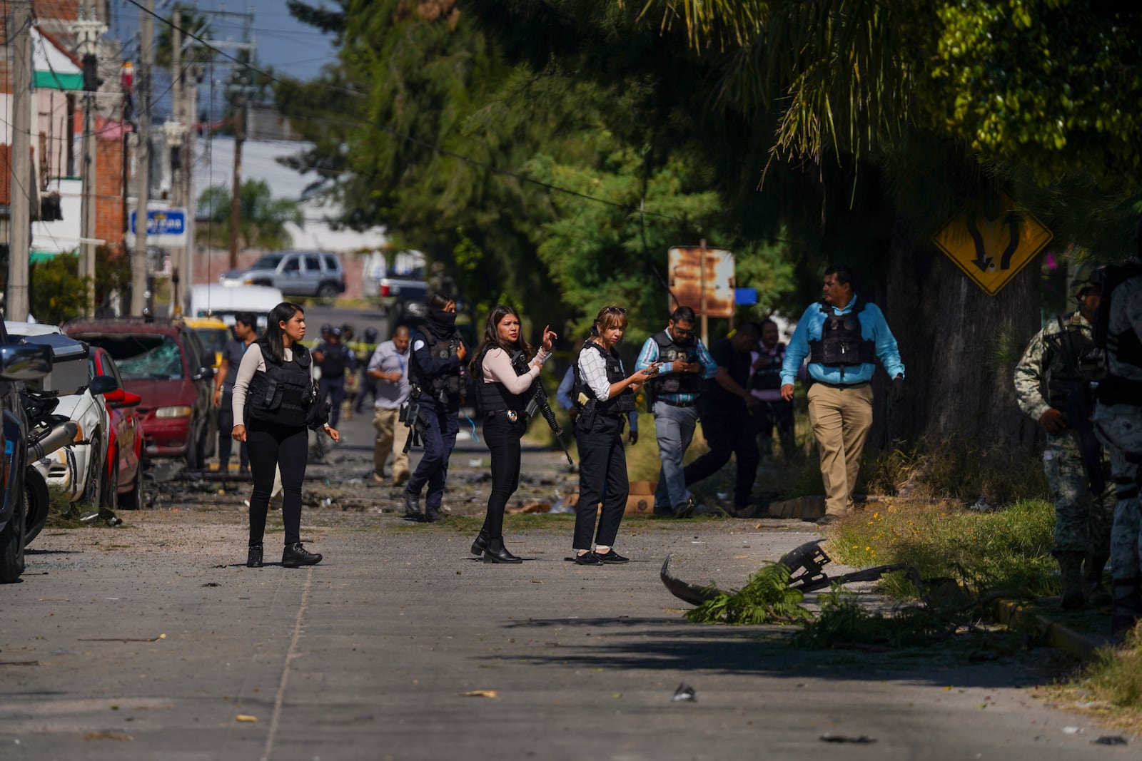 Security agents and experts on the scene where a car bomb exploded near a police station, in Acambaro, Guanajuato state, Mexico, Thursday, Oct. 24, 2024. (AP Photo/Armando Solis)