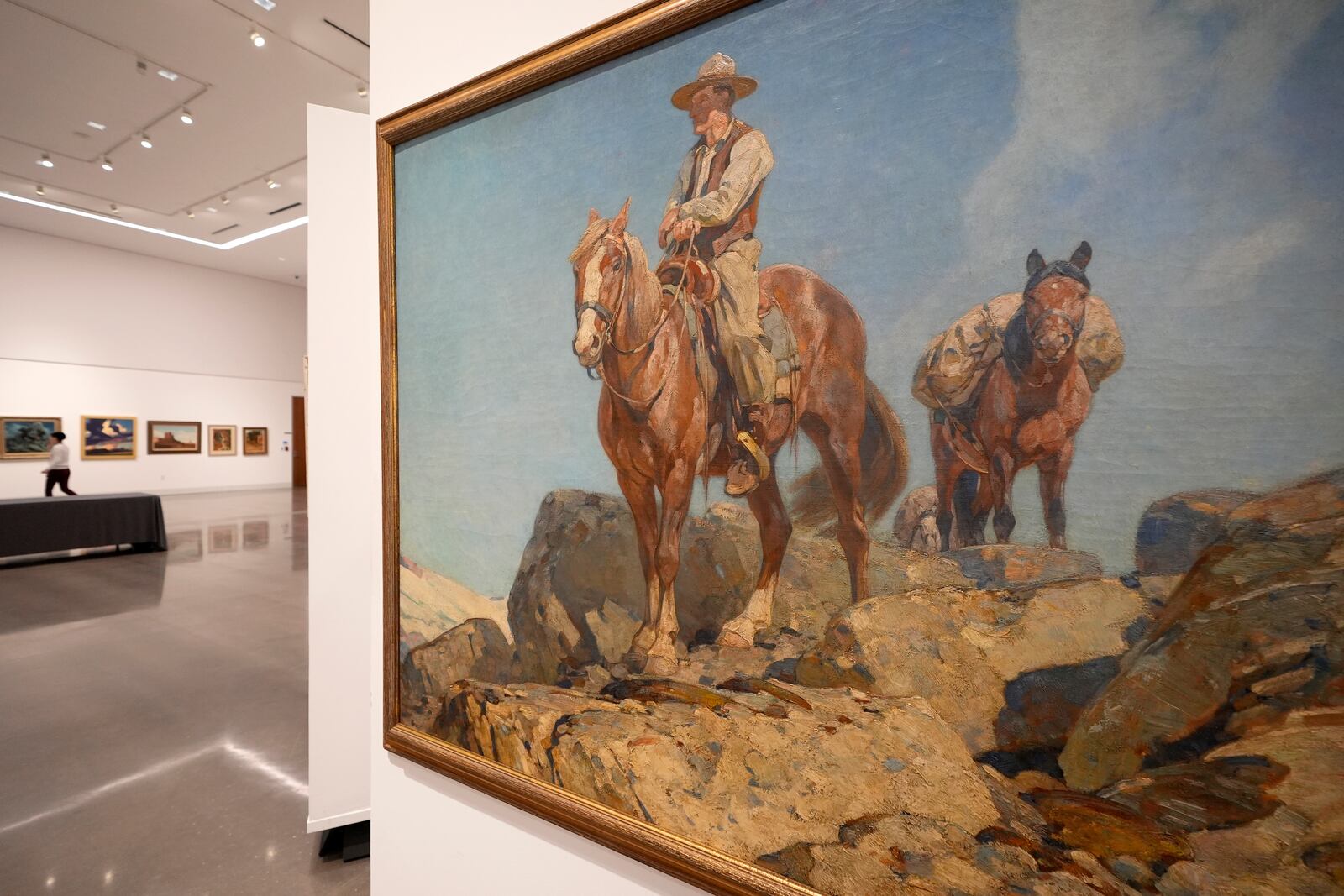 A painting that hangs at Heritage Auctions in Dallas, Thursday, Oct. 17, 2024, is just one of many works from the Boy Scouts of America's art collection — including some paintings by Norman Rockwell — that will go up for auction this month to help compensate tens of thousands of people, mainly men, who were sexually abused while in scouting. (AP Photo/Tony Gutierrez)