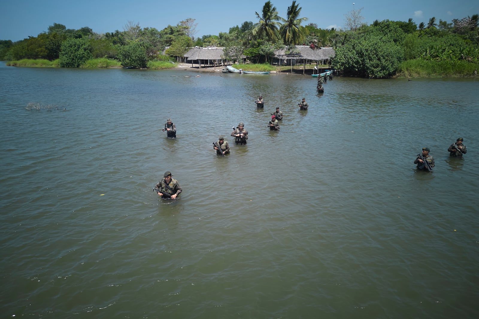 Guatemalan soldiers patrol the shared border with Mexico as part of the Ring of Fire operation, aiming to strengthen border control, in the Suchiate River in Ocos, Guatemala, Thursday, March 13, 2025. (AP Photo/Moises Castillo)