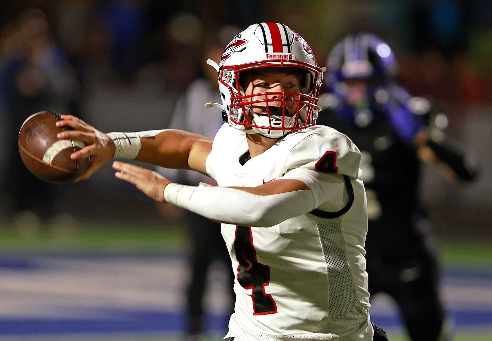 Tipp quarterback Larkin Thomas throws down field during Friday's game against Xenia. BILL LACKEY/STAFF