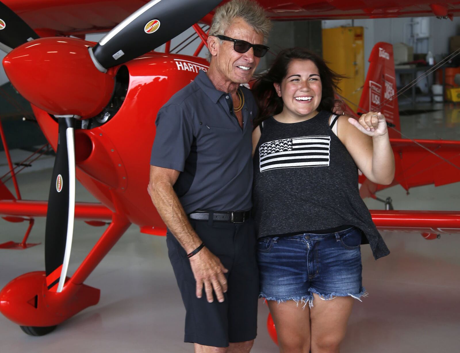 Annie Stemen, 17, from Sidney, smiled and laughed during her entire flight with Sean D. Tucker while flying for the first time in the Young Eagles program run by the Experimental Aircraft Association. Tucker, a National Aviation Hall of Fame inductee, flew Stemen on Thursday before the weekend Vectren Dayton Air Show where he will perform. TY GREENLEES / STAFF