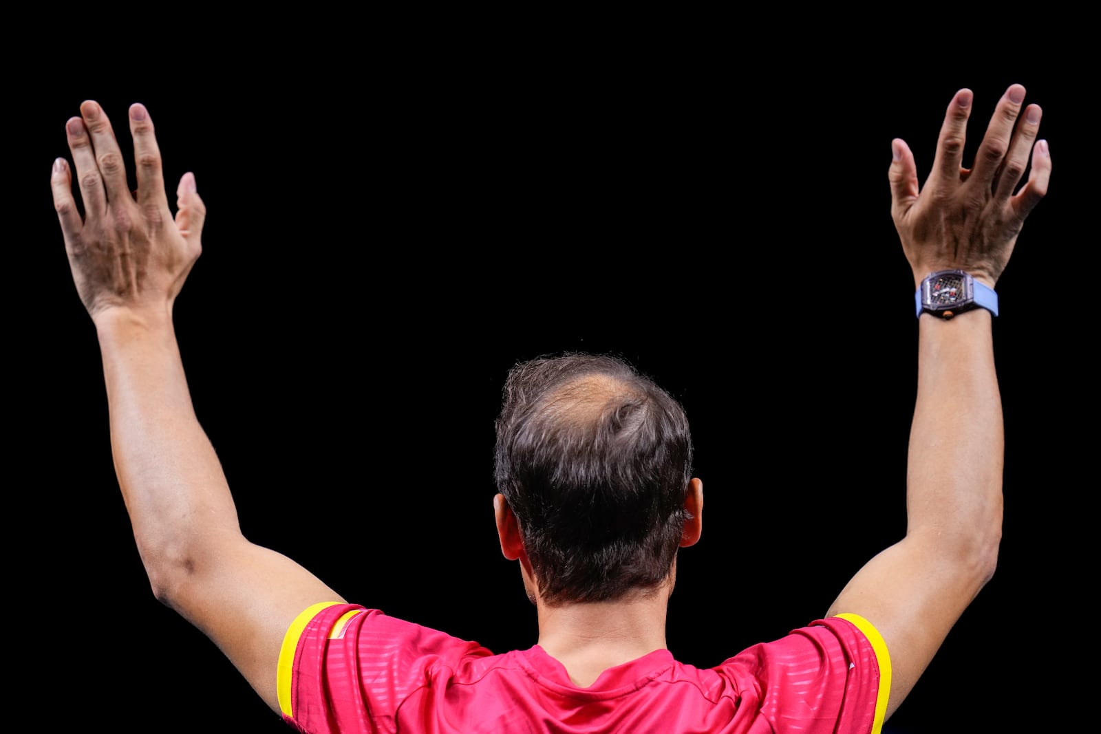 Spain's Rafael Nadal waves to the crowd during a tribute after playing his last match as a professional tennis player in the Davis Cup quarterfinals at the Martin Carpena Sports Hall in Malaga, southern Spain, on early Wednesday, Nov. 20, 2024. (AP Photo/Manu Fernandez)